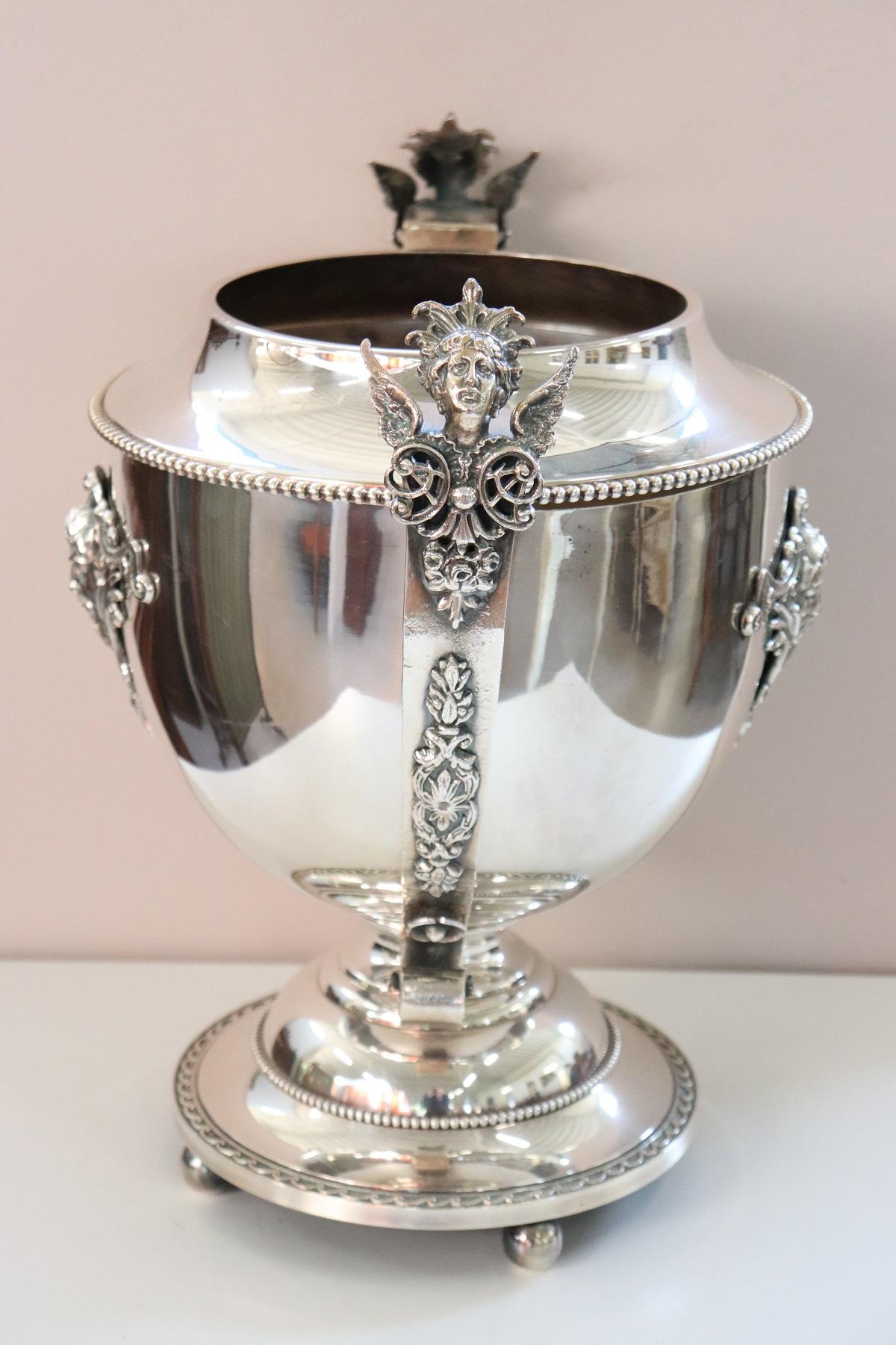 Beautiful 20th century silver plate champagne bucket or wine cooler. Refined finely chiseled decorations sumptuous handles with figures. Perfect for serving wine with elegance on important occasions.