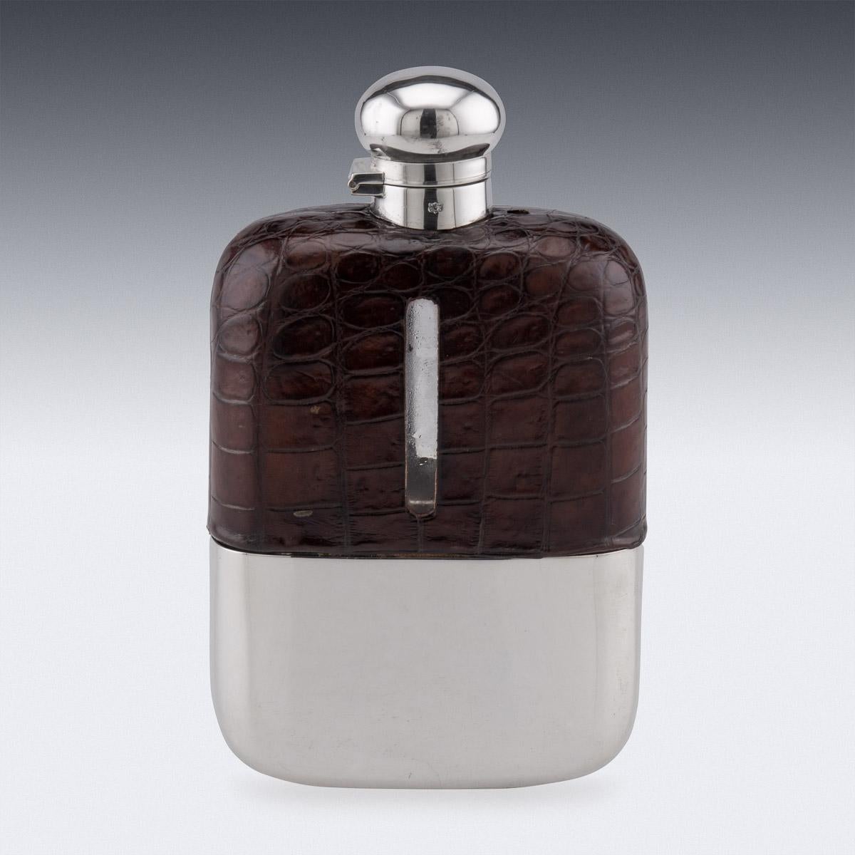 20th century Edwardian silver plated, blown glass and sumptuous crocodile leather hip flask, unusually large, of rounded rectangular form, with a pull off cup with gilt interior, top mounted with a large hinged lid. Hallmarked with English silver
