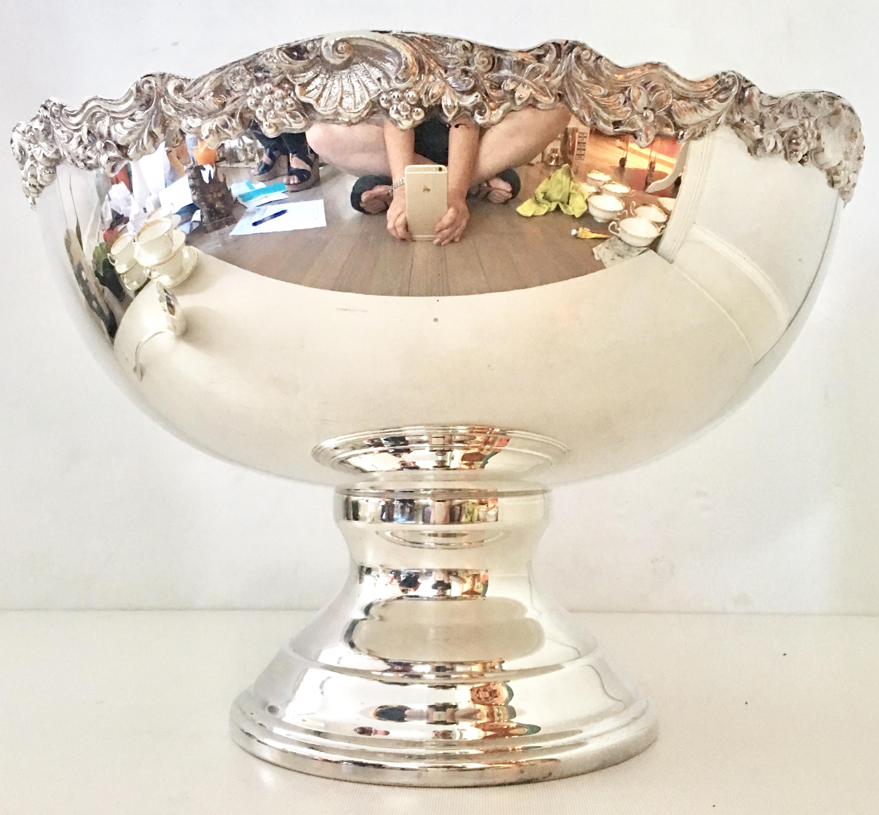20th century silver plate footed punch bowl by, Towle Silversmiths. Features a shell, floral berry vine motif at the top rim. Signed on the underside, Towle silver plated.