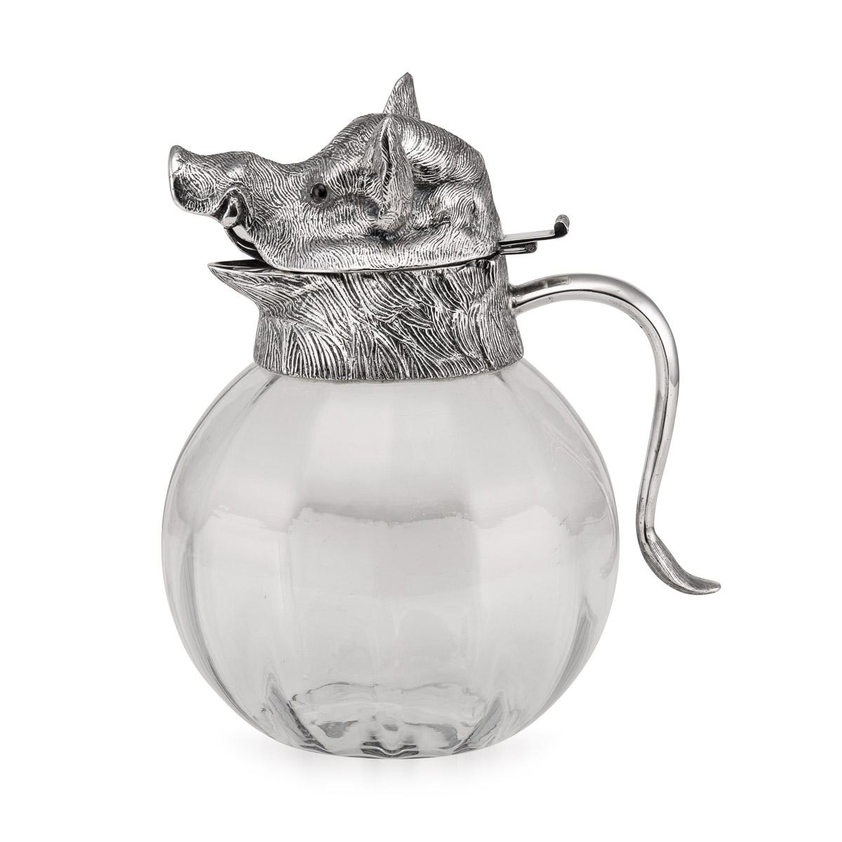 Superb mid-20th Century silver plated mounted novelty claret jug modelled as a boars head, with plain glass body, the tail forming the handle, hinged head set with glass eyes, accompanied by a set of four cups, hallmarked with the makers mark