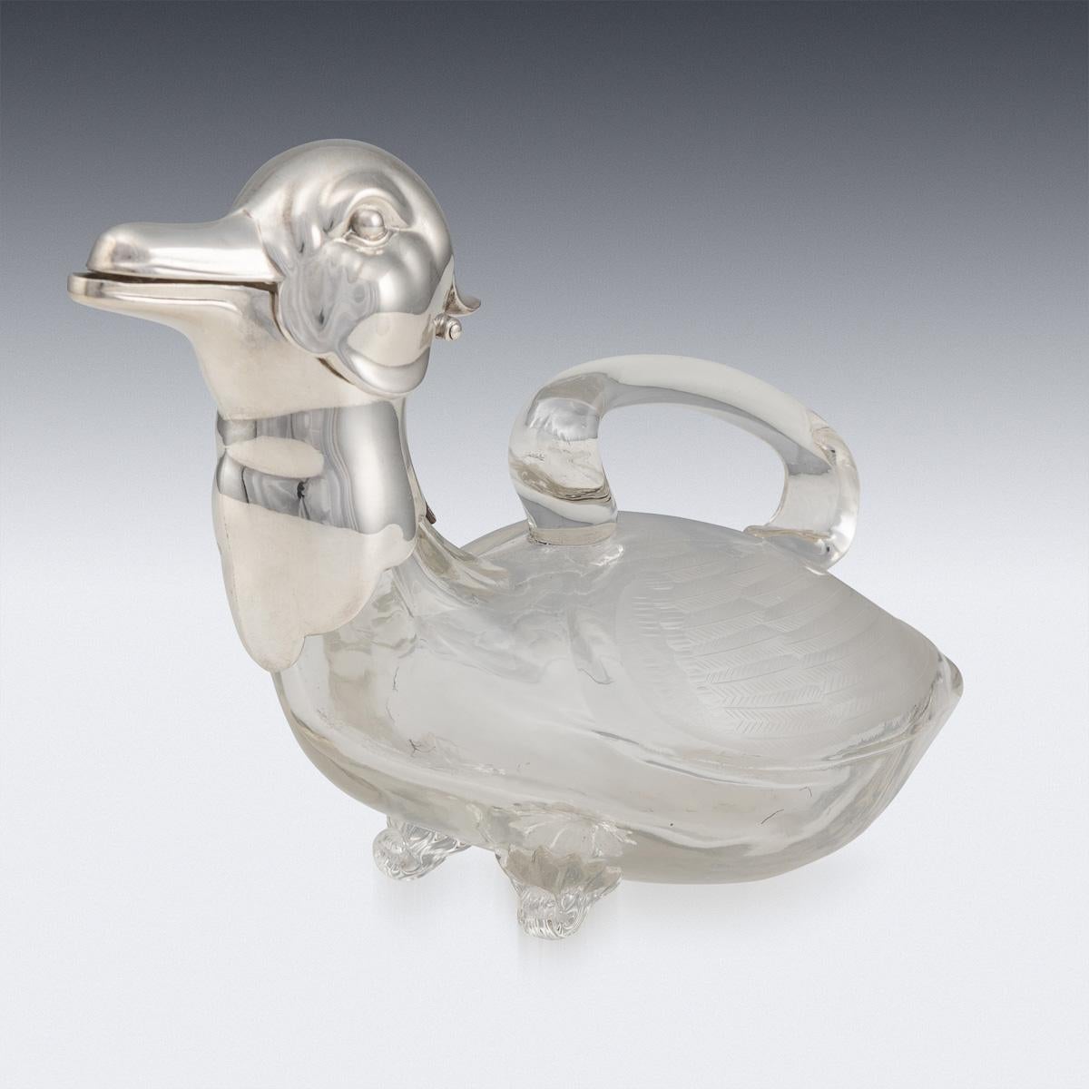 Superb mid-20th century silver plated mounted novelty claret jug modelled as a duck, plain glass body, the wings forming the handles, hinged head set with glass eyes. Such novelty claret jugs are rare and sought after. It is easy to imagine the