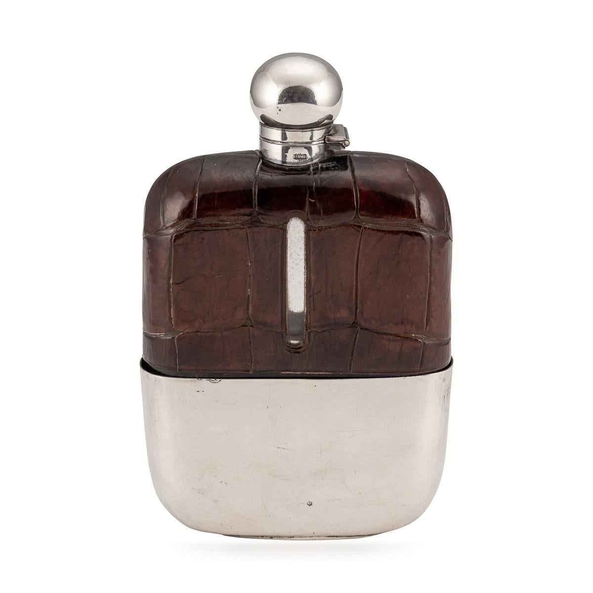 A stunning hip flask made by James Dixon and Sons. Made out of glass and then mounted with crocodile leather with a silver plated bayonet locking mechanism and removable cup, these hip flasks were extremely popular around the turn of the last