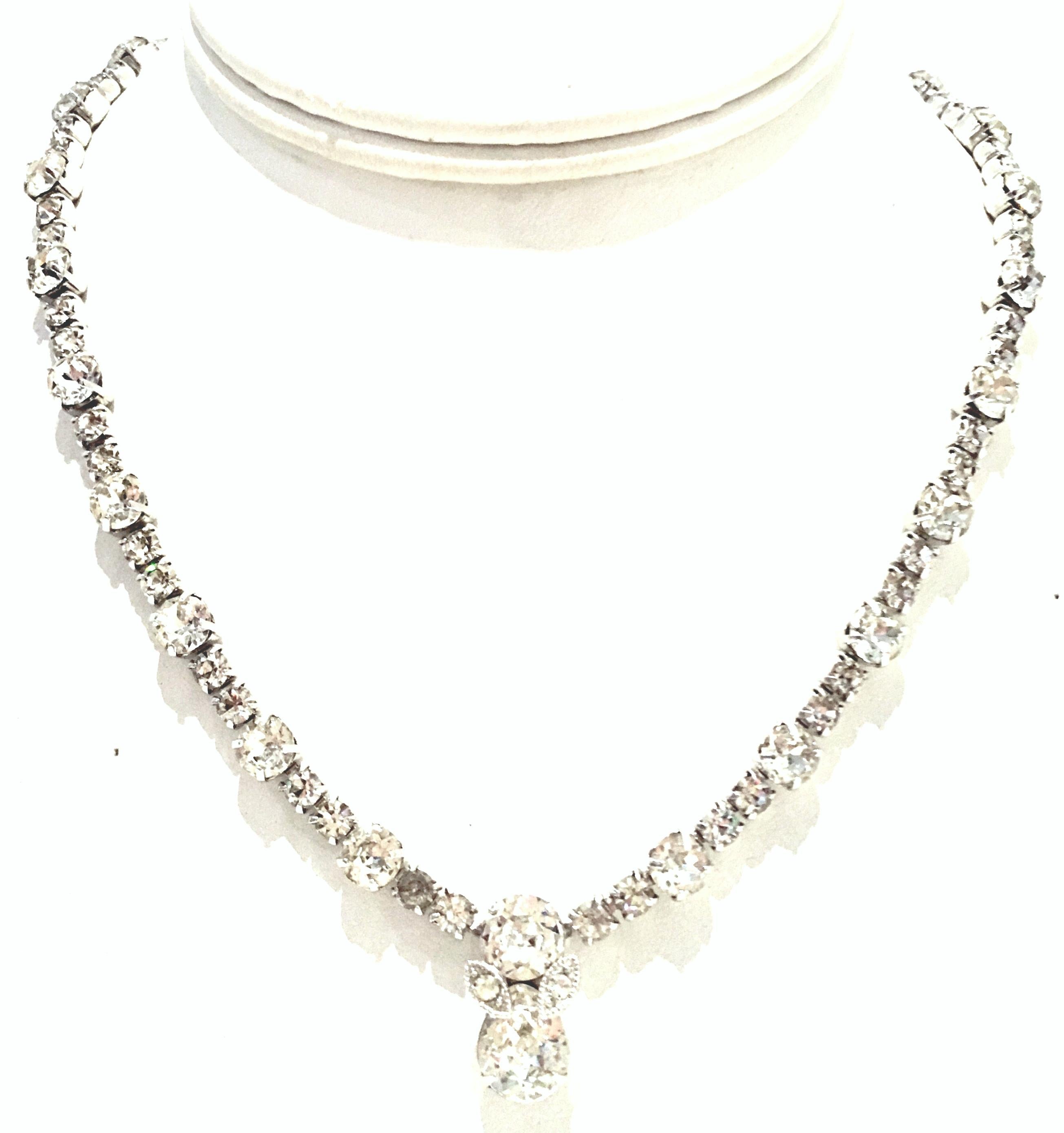 20th Century Silver & Swarovski Crystal Choker Style Necklace By, Eisenberg. This silver rhodium plate necklace features the highest quality of prong set colorless stones with a central and large ornament of approximately, .75