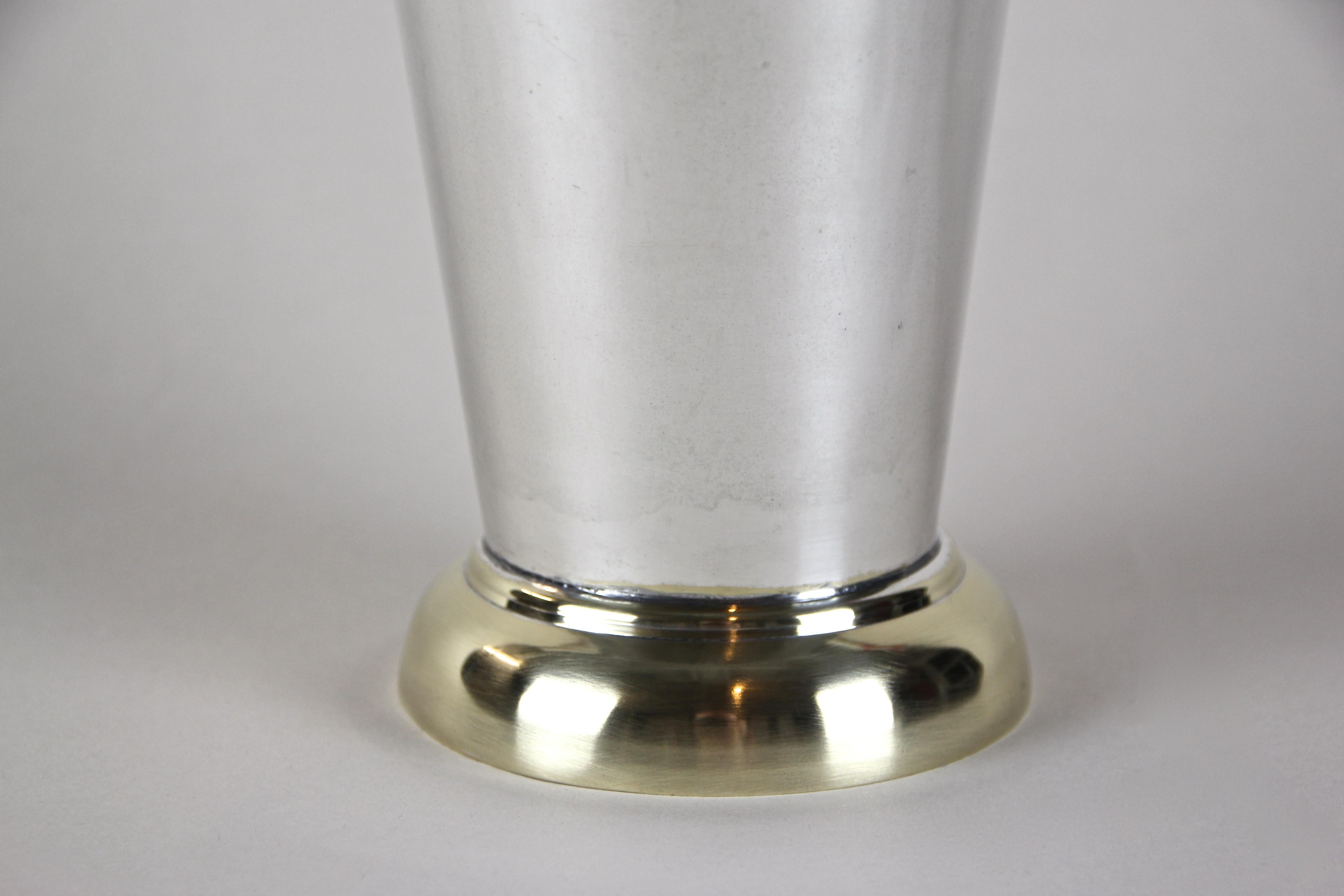 Fine early 20th century silvered brass vase from the Art Deco period in Austria, circa 1920. Shaped like a drop, the timeless designed brass vase shows a beautiful silvered surface standing on a polished brass base. A simple but impressing piece of