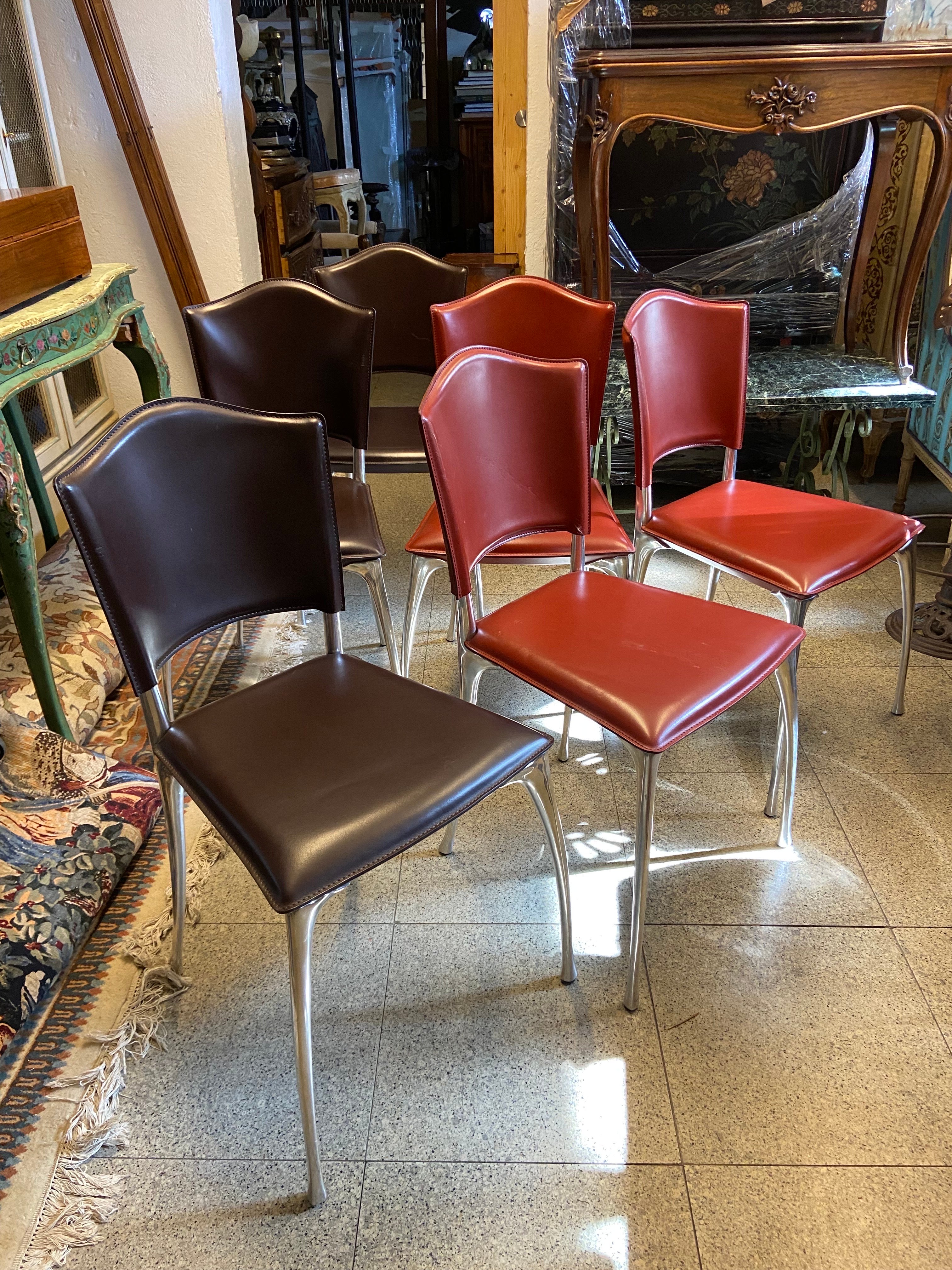 Six leather chairs model Lea by Bernard Dequet ?? 1990 ?. Aluminium base and leather seats and backs in red and brown.
  