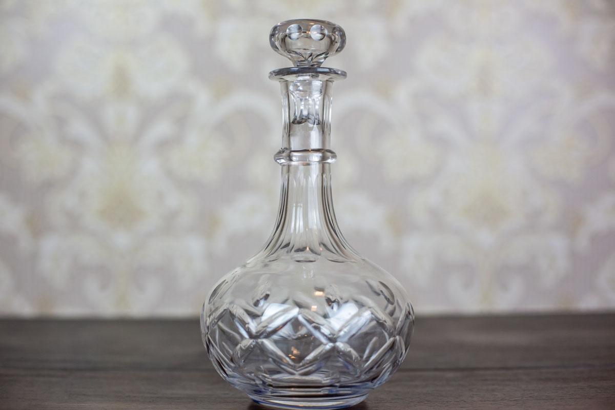 The glass is crystal, with a delicate cut.

This item is in very good condition and undamaged.