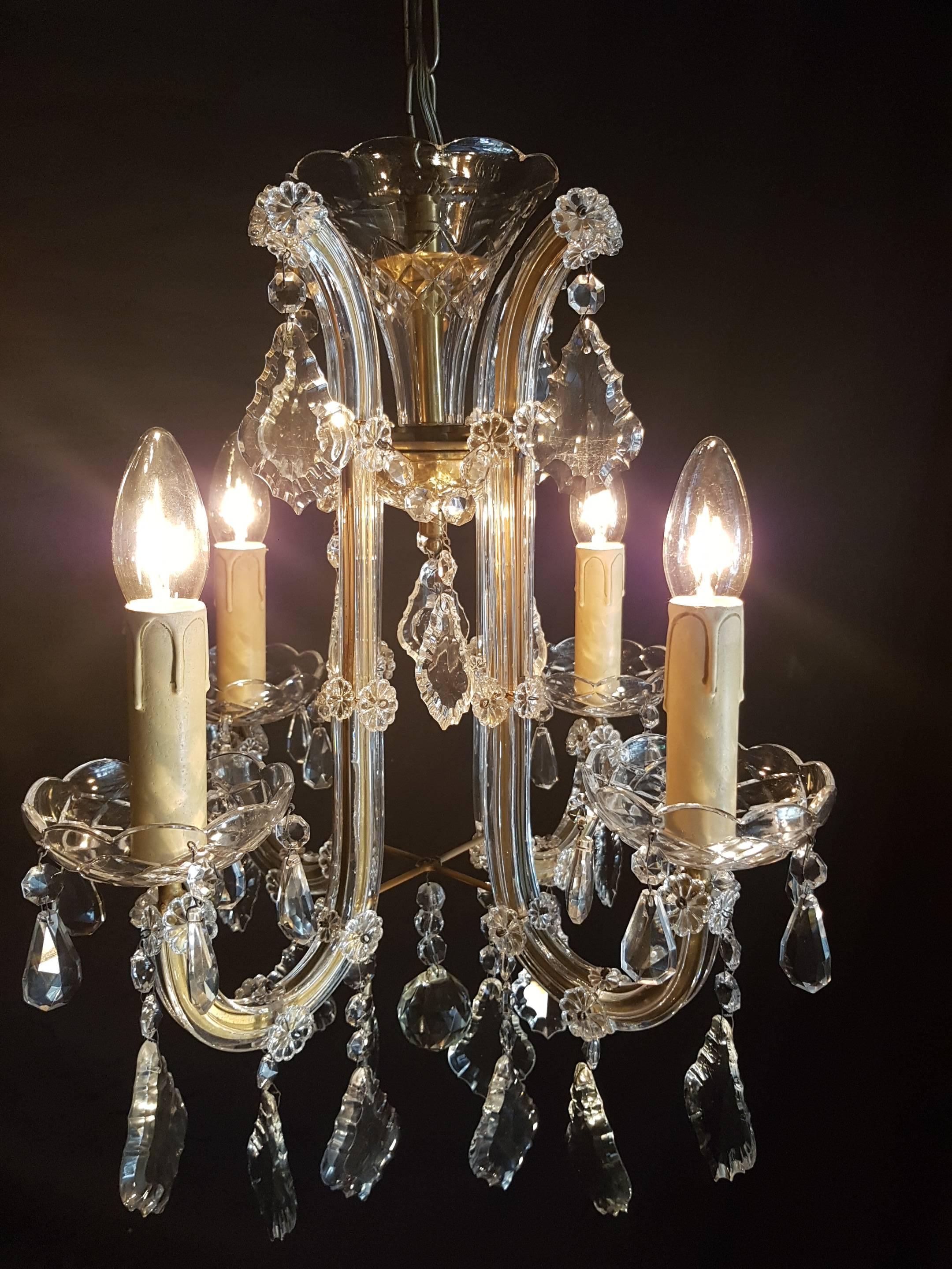 Very nice four-light Maria Theresia chandelier with crystal and glass.
This is just one of our large collection chandeliers. Besides the old and antique chandeliers we have a beautiful series of new large chandeliers in the Maria Theresia style.
 