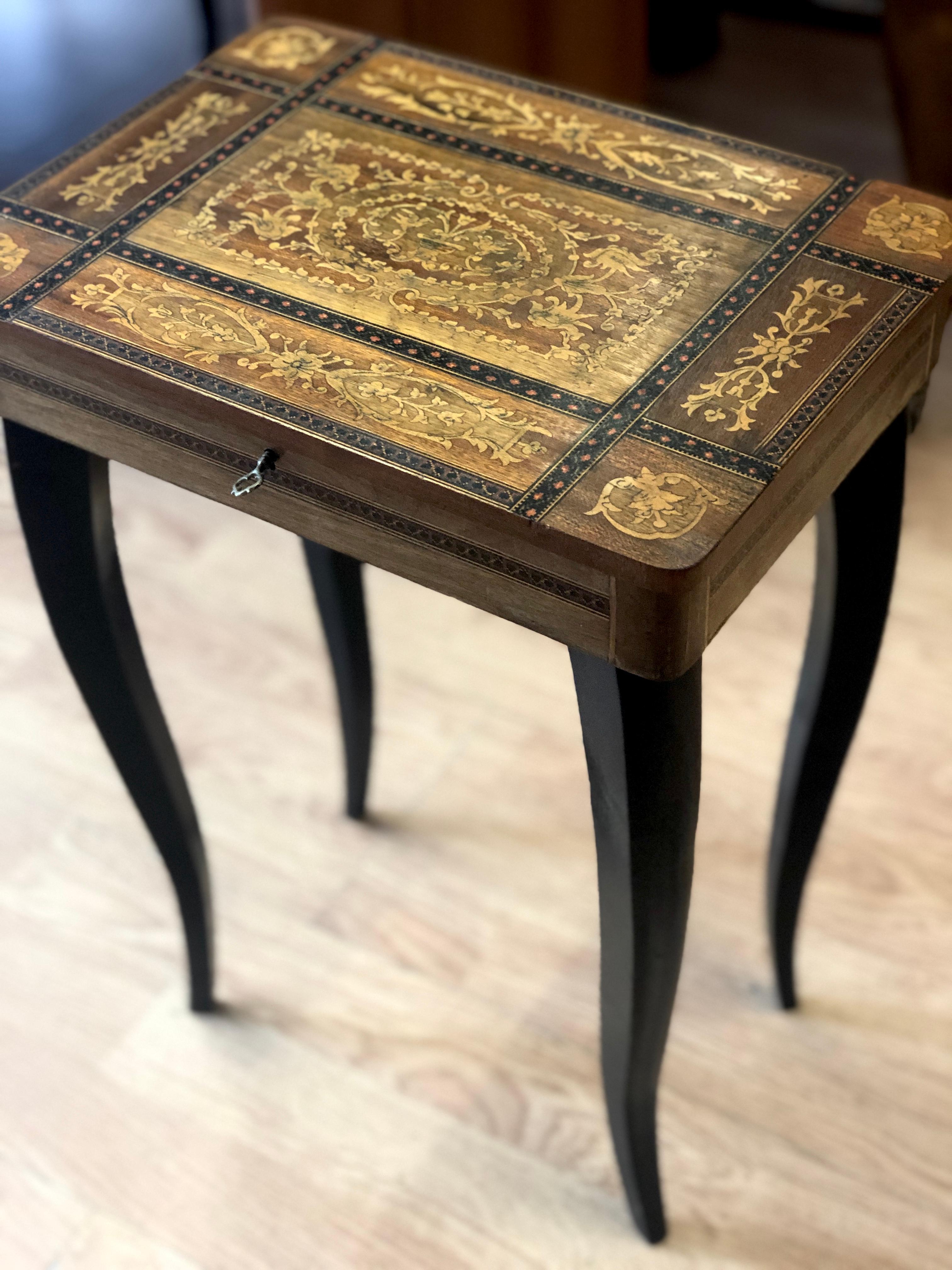 20th century small French rectangular wood side or end table with decorative inlaid top, cabriolet legs, private jewelry compartment upholstered with blue silk and music box with delicate dancer. The original key is available.