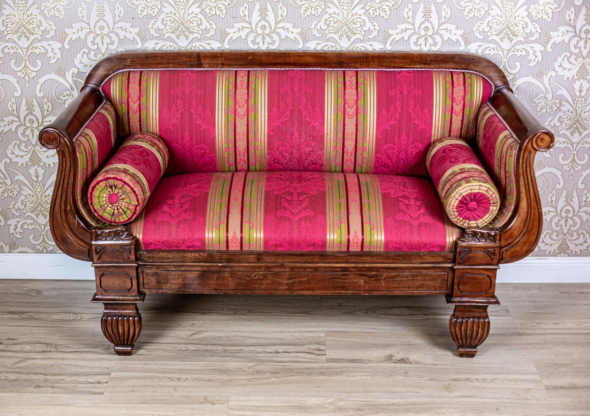 We present you a small sofa from the second half of the 20th century, stylized as Biedermeier.
The backrest is simple, with the armrests rolled outwards.

This piece of furniture is in perfect condition.

The upholstery has been replaced with a