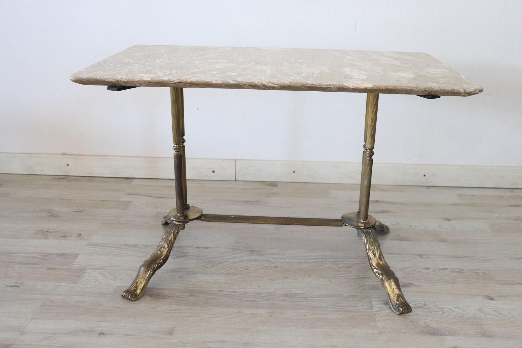Rare and fine quality 1950s rectangular sofa table or coffee table. The table in precious gilded bronze. The top is in marble. The bronze shows signs of wear and ancient patina.