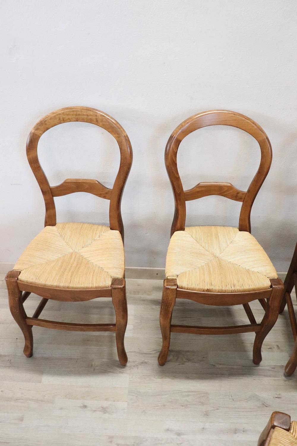 20th Century dining room set of six chairs in solid beech wood. The chairs are very elegant with very slender and solid moving legs. The seat is wide and comfortable in rustic straw. The chairs are in perfect condition ready to be used in your