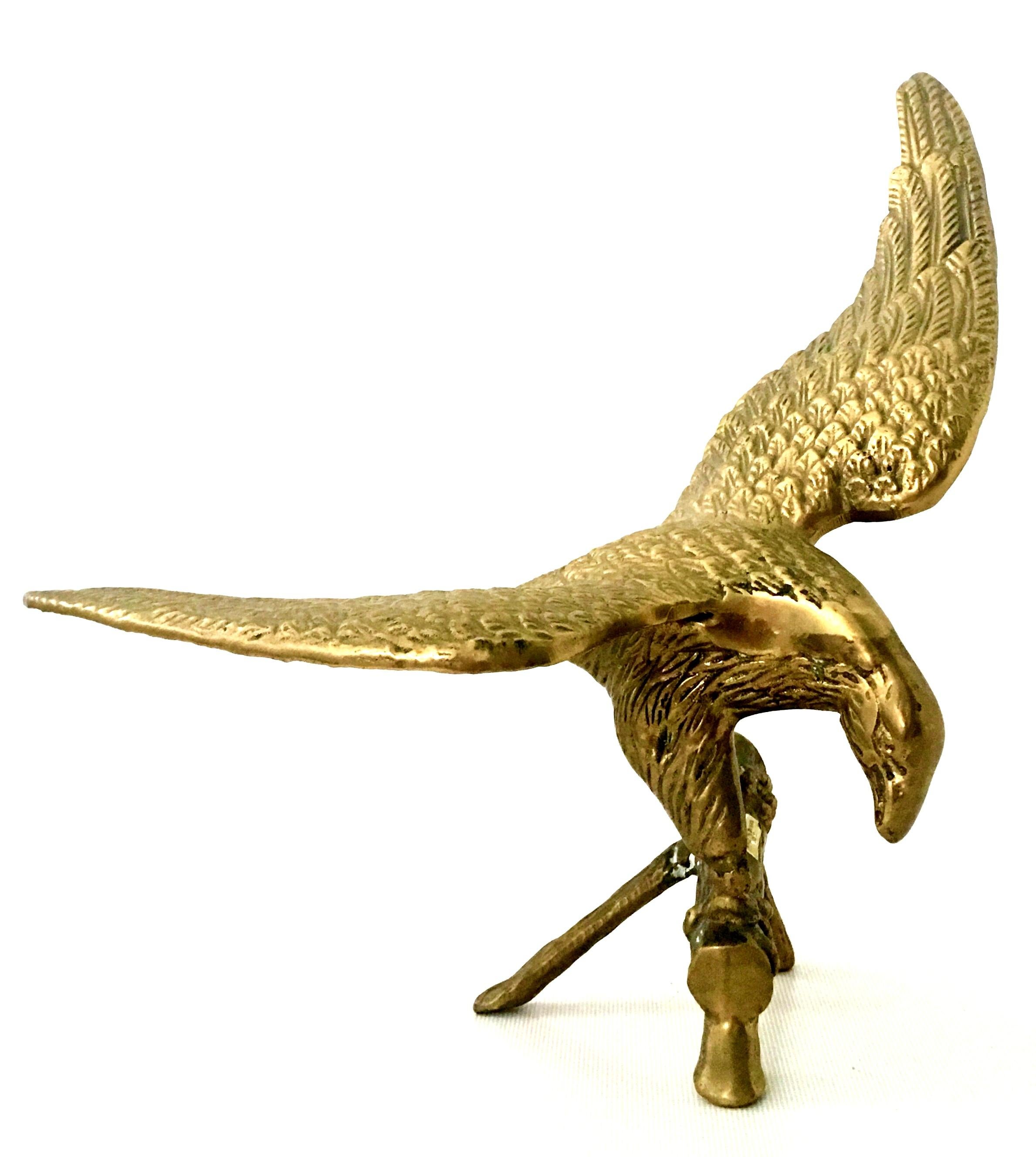 20th Century polished solid brass perched eagle sculpture. Features a finely crafted and expertly detailed eagle about to take flight perched on a faux bois tree branch.