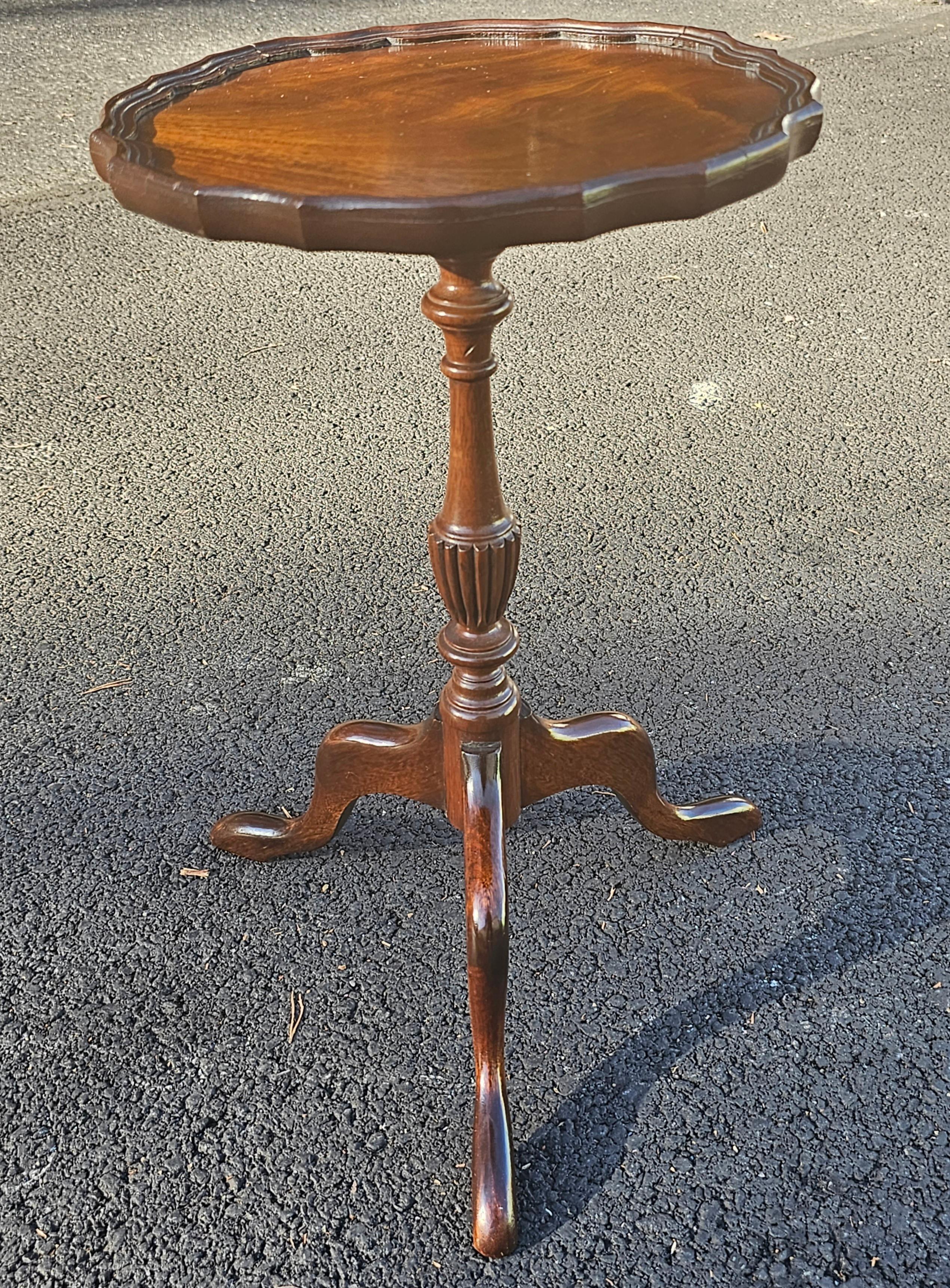 An Early 20th Century Refinished Solid Mahogany Pedestal Tripod Pie Crust Candle Stand with Snake Feet. 
Measures 12