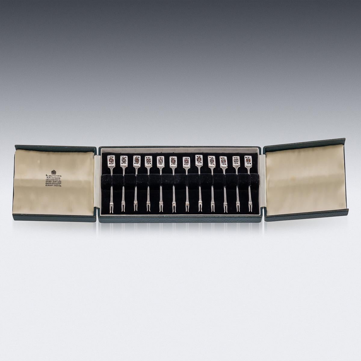 20th Century British solid silver set of twelve cocktail picks, decorated with enamels depicting playing cards. The set comes in its original leatherette and velvet lined box. Each piece is Hallmarked English silver (925 Standard), Birmingham, year