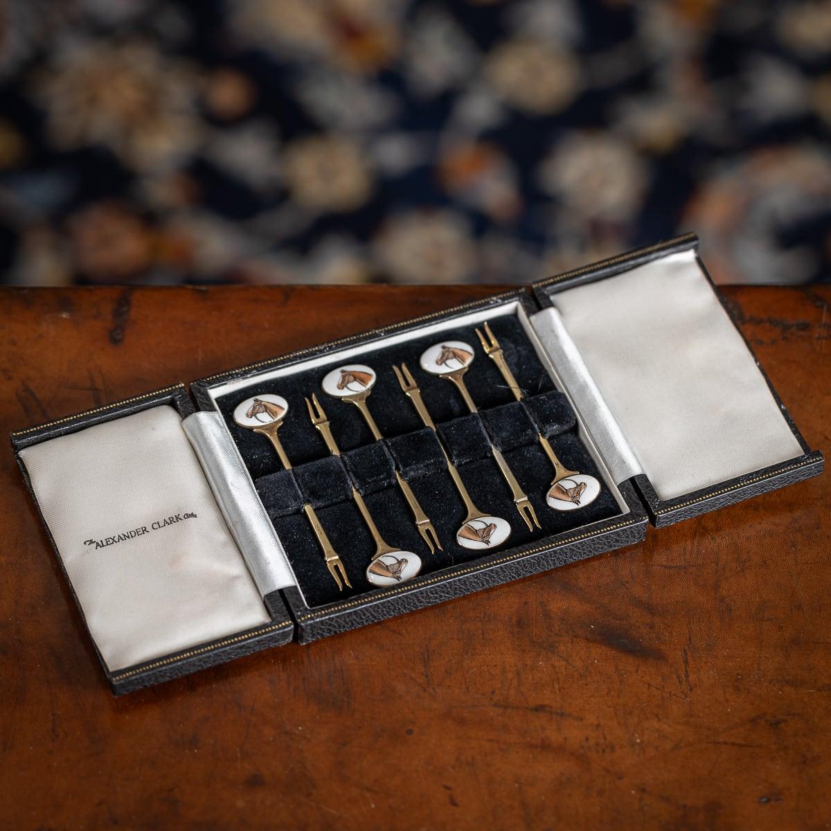 Mid 20th Century British solid silver-gilt set of six cocktail picks, decorated with enamels depicting race horses. The set comes in its original leatherette and velvet lined box. Each piece is Hallmarked English silver (925 Standard), Birmingham,