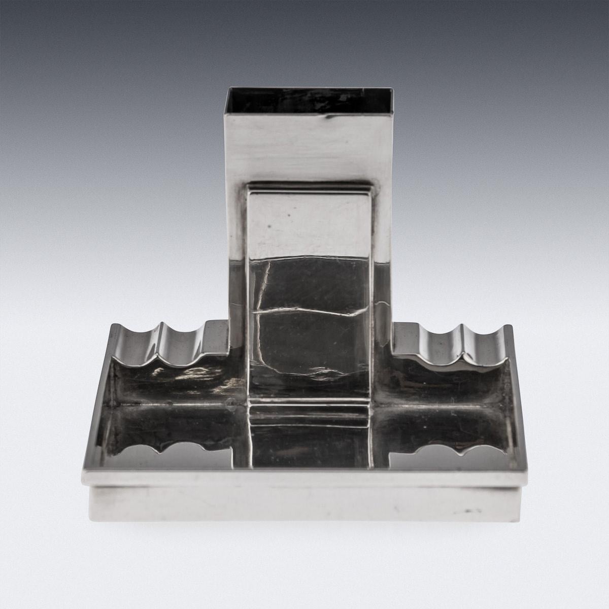 A fantastic mid-20th Century English solid silver ashtray with match striker by Walker & Hall. Featuring a rectangular ashtray with four spaces to rest a cigar. In the centre, a space to store a matchbox, allowing the striker to be visible and