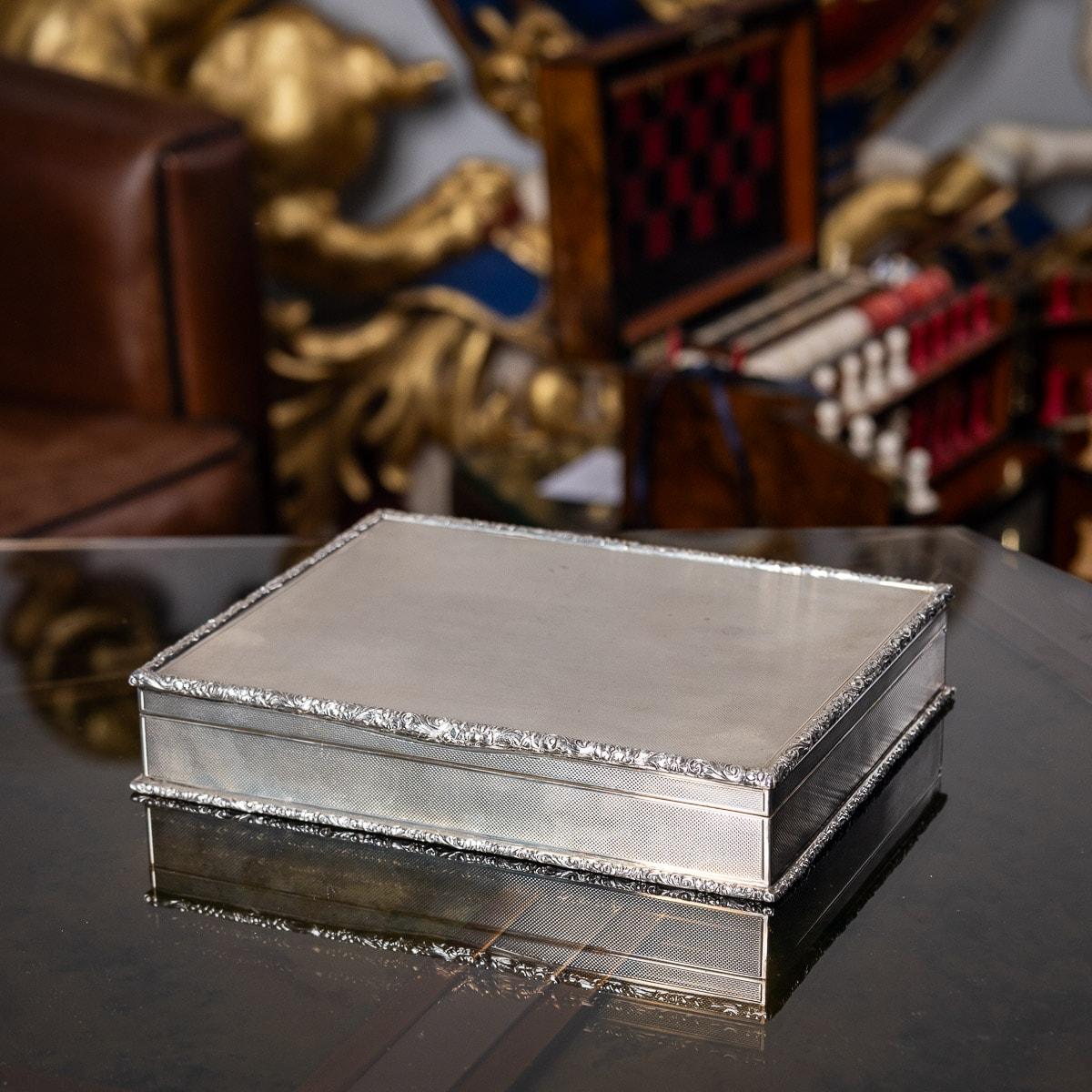 Elegant mid-20th century solid silver cigar box, beautiful and very stylish engine-turned design, applied with a cast scroll boarders, inside richly gilt and wooden lining, the base is lined with black leather. Hallmarked English silver (925