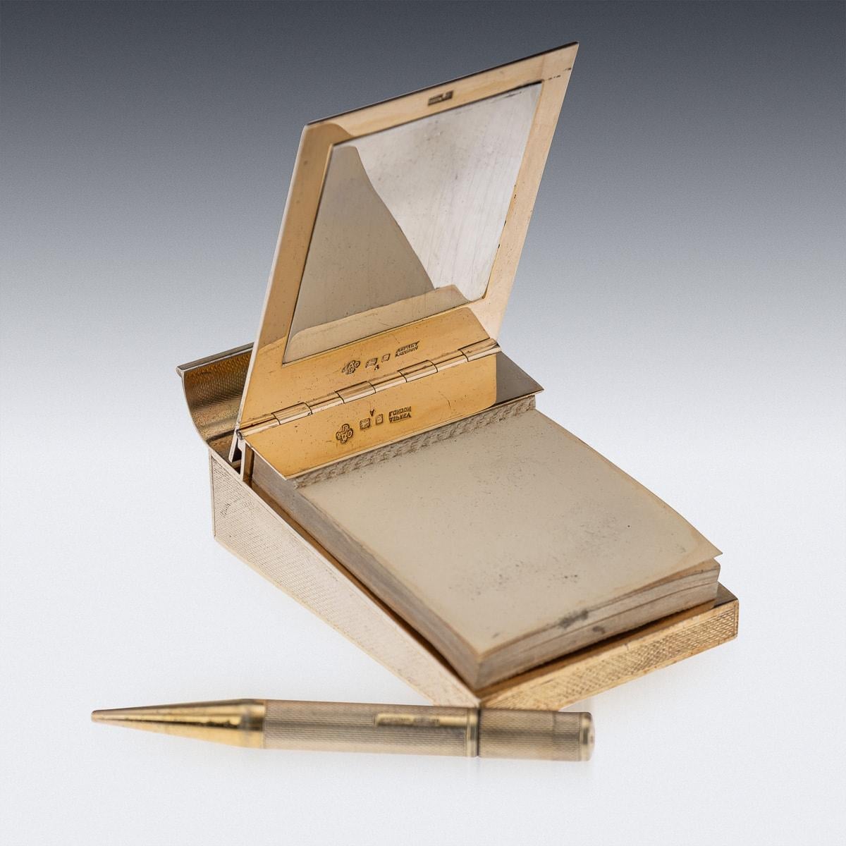 Stunning mid-20th Century English solid silver gilt notepad and pencil. This writing set features an engine turn decoration on the outside and a fitted pencil. Created by the renowned London silversmith Asprey of London, this rare and unique piece