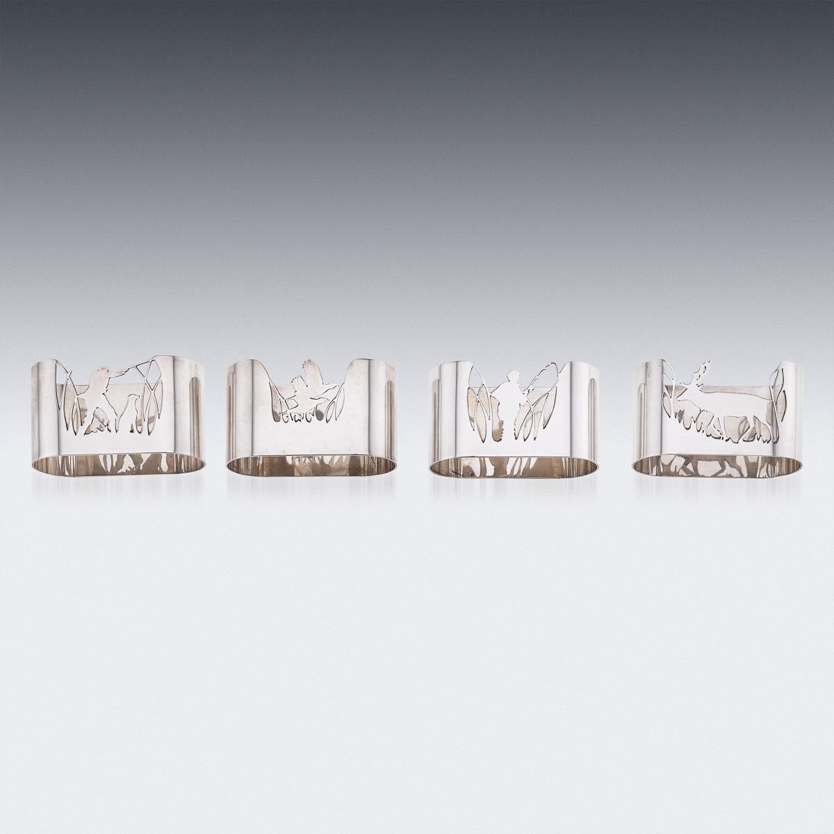 20th Century stunning set of four solid silver napkin holders. Each napkin holder is pierced depicting a hunter and stag, fisherman and game birds. The set comes in an original retail case. Each napkin holder is hallmarked English silver (925