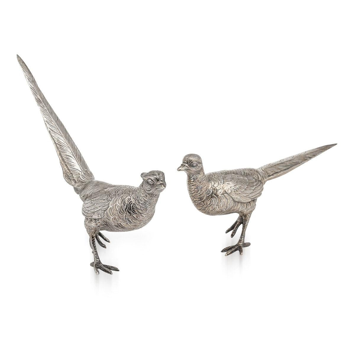 Mid 20th Century solid silver pair of pheasants, very ornamental and well refined. Each statue is naturalistically modelled as a standing bird, perfect to use as a table ornament. The male pheasant is slightly larger than the female. A perfect