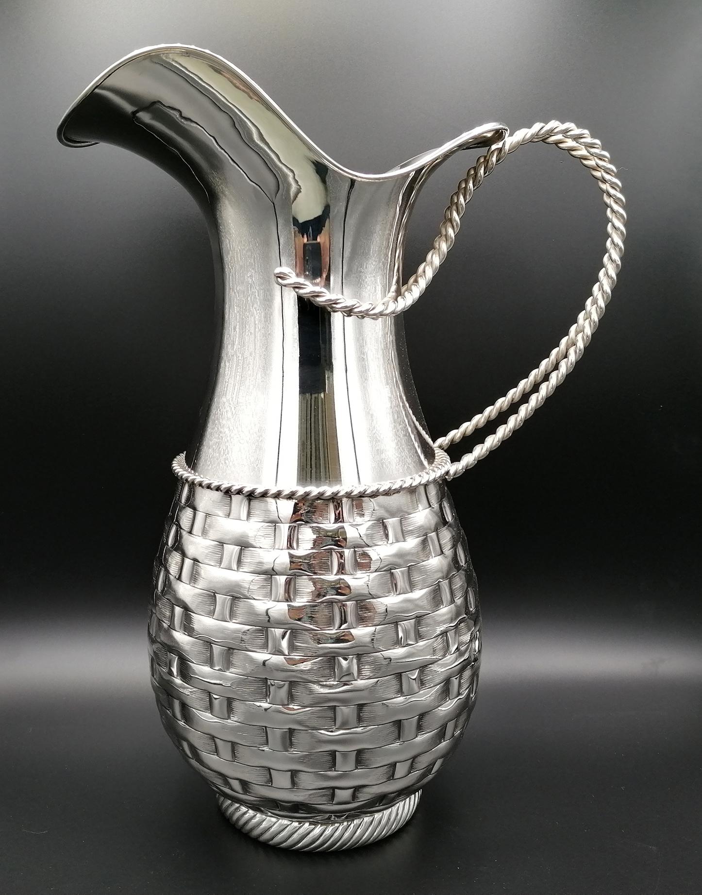 Handmade 800 silver jug. Embossed and chiseled with straw design. The handle and the median frame is a braided cord made from 2 solid silver wires. The base of the jug is chiseled with a torchon design
1670 grams.