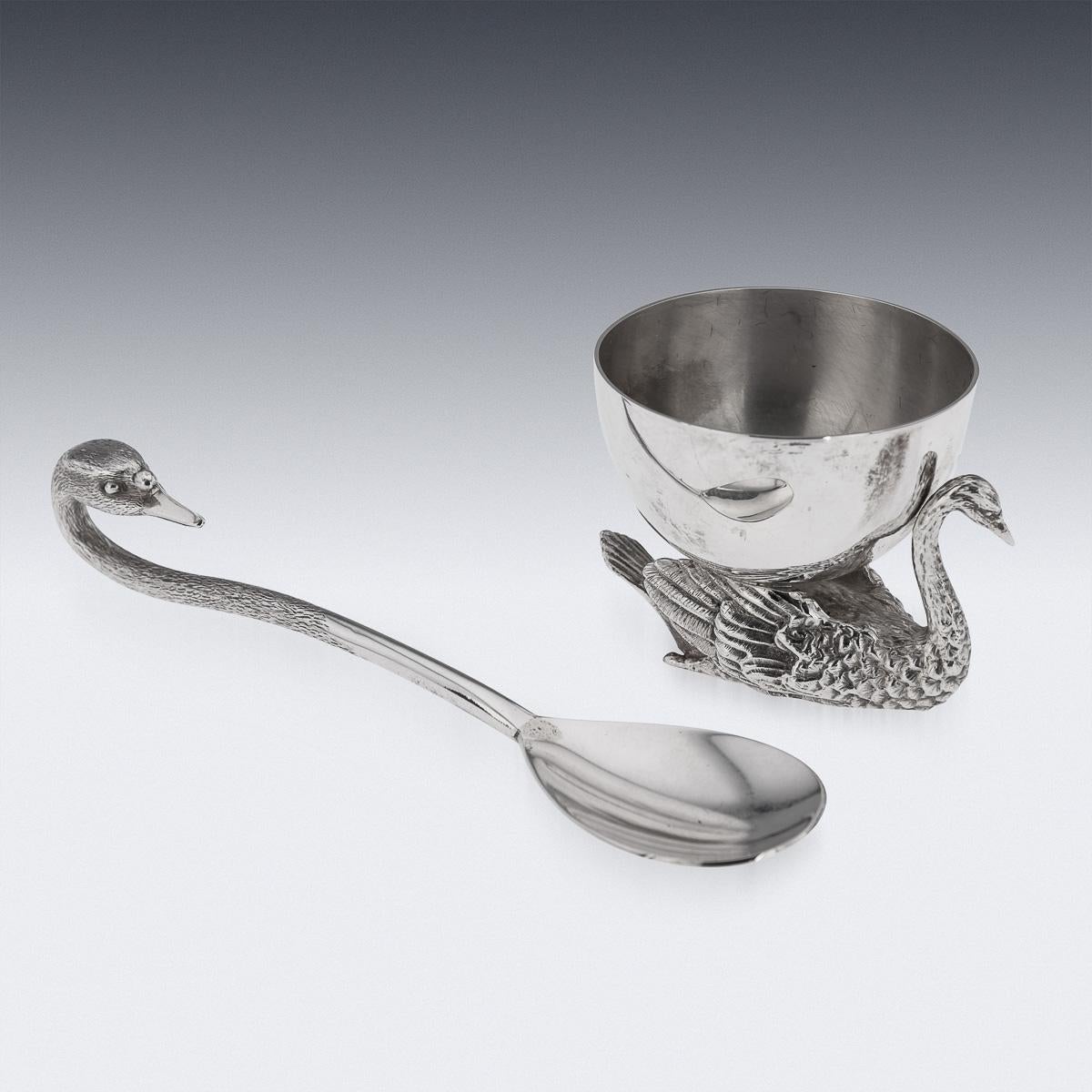 Late 20th Century solid silver novelty swan shaped salt & spoon, beautifully cast and realistically modelled as a swan, the body cast with a detailed textured plumage holding a plain bowl. Hallmarked English silver (925 standard), London, year 1992