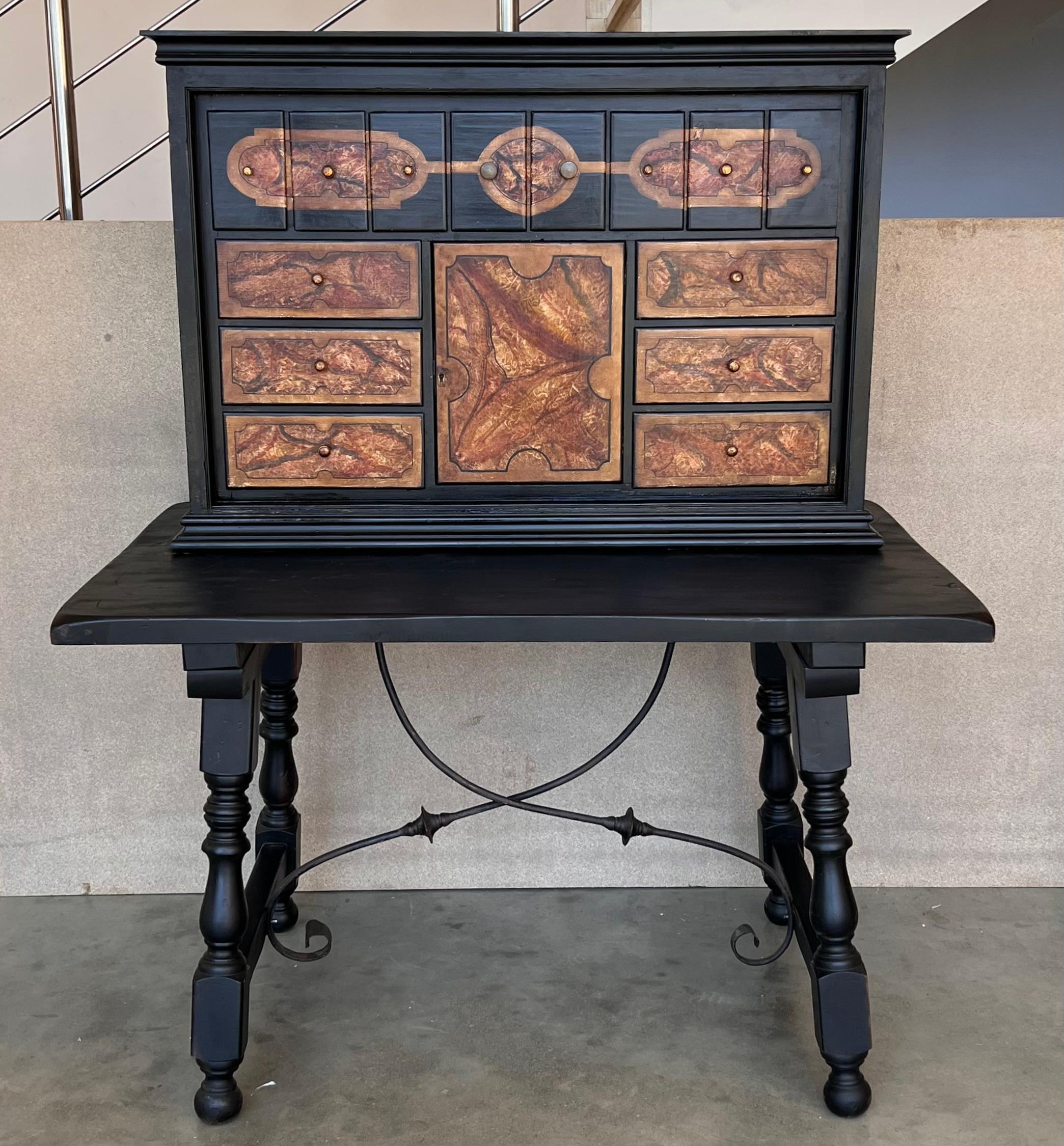This Bargueno is a portable desk. The base is typically a Spanish table and dates from 19th Century. The upper part was added in the 20th century in England and dates from the Arts and Craft movement. A movement recognizable in its different