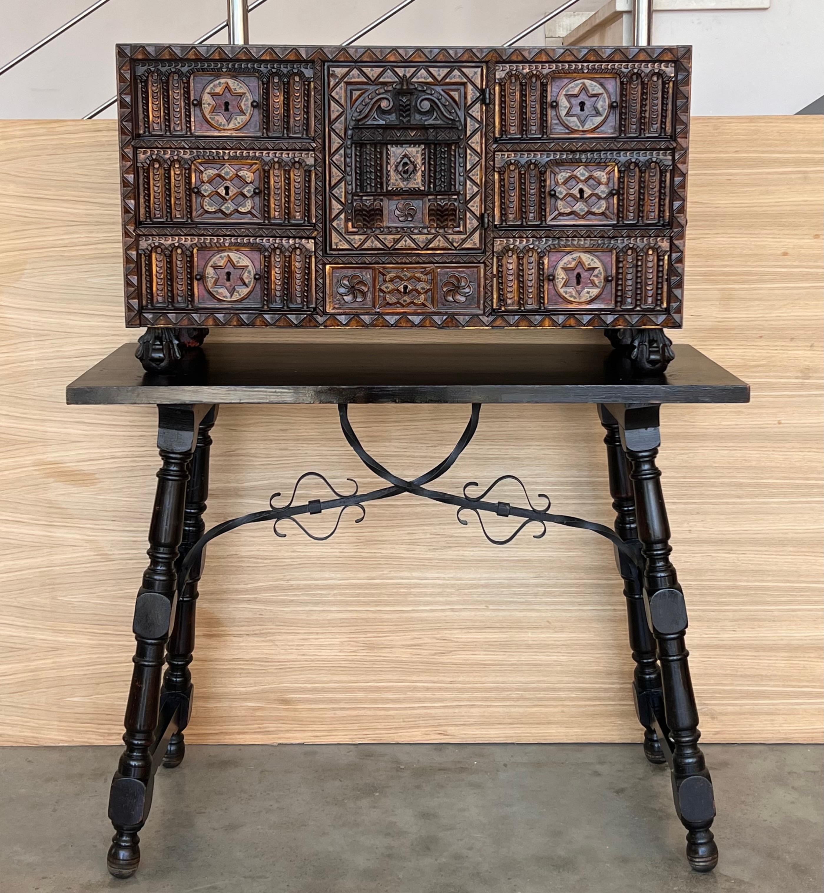 An 18th century Spanish bargueno or vargueno traveling desk, used for storing documents, jewels, or sewing box. The seven drawers chest is inset with bone, walnut, mahogany and heavily gilded. Featuring original iron hardware and an old auction