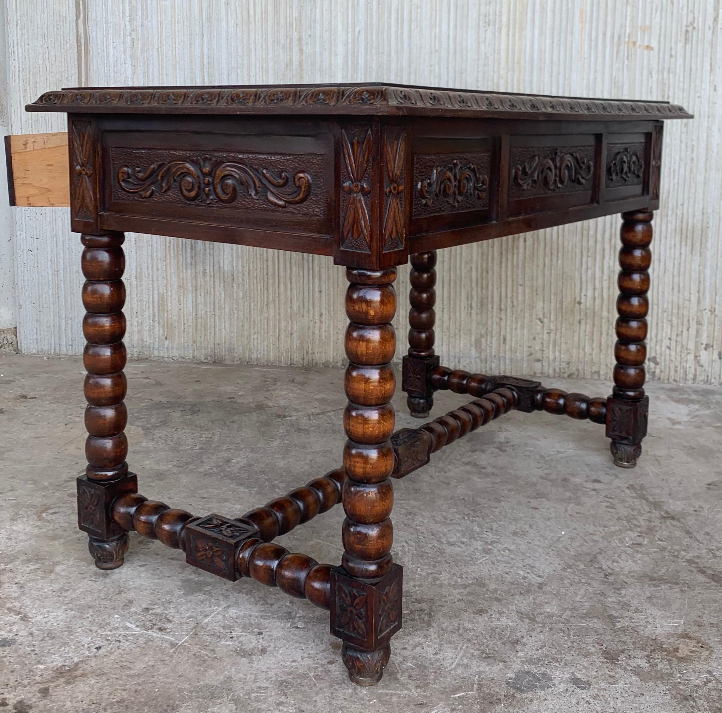 Handsome oak library piece that can be used as a desk or work table. Made of oak having carved gadrooned edges. A stretcher made of wood. Carved on all sides and three drawers, Early 20th century.
Workable locks and key.

Measures: Height to the