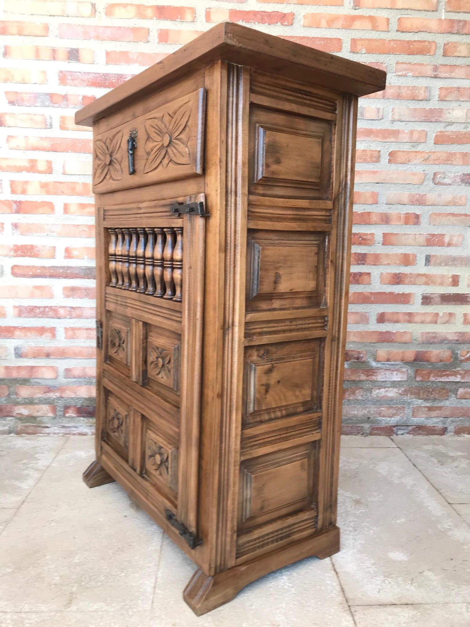 From Northern Spain, constructed of solid walnut, the rectangular top with molded edge atop a conforming case housing two drawers over two doors, the doors paneled with solid walnut, raised on a plinth base.

  