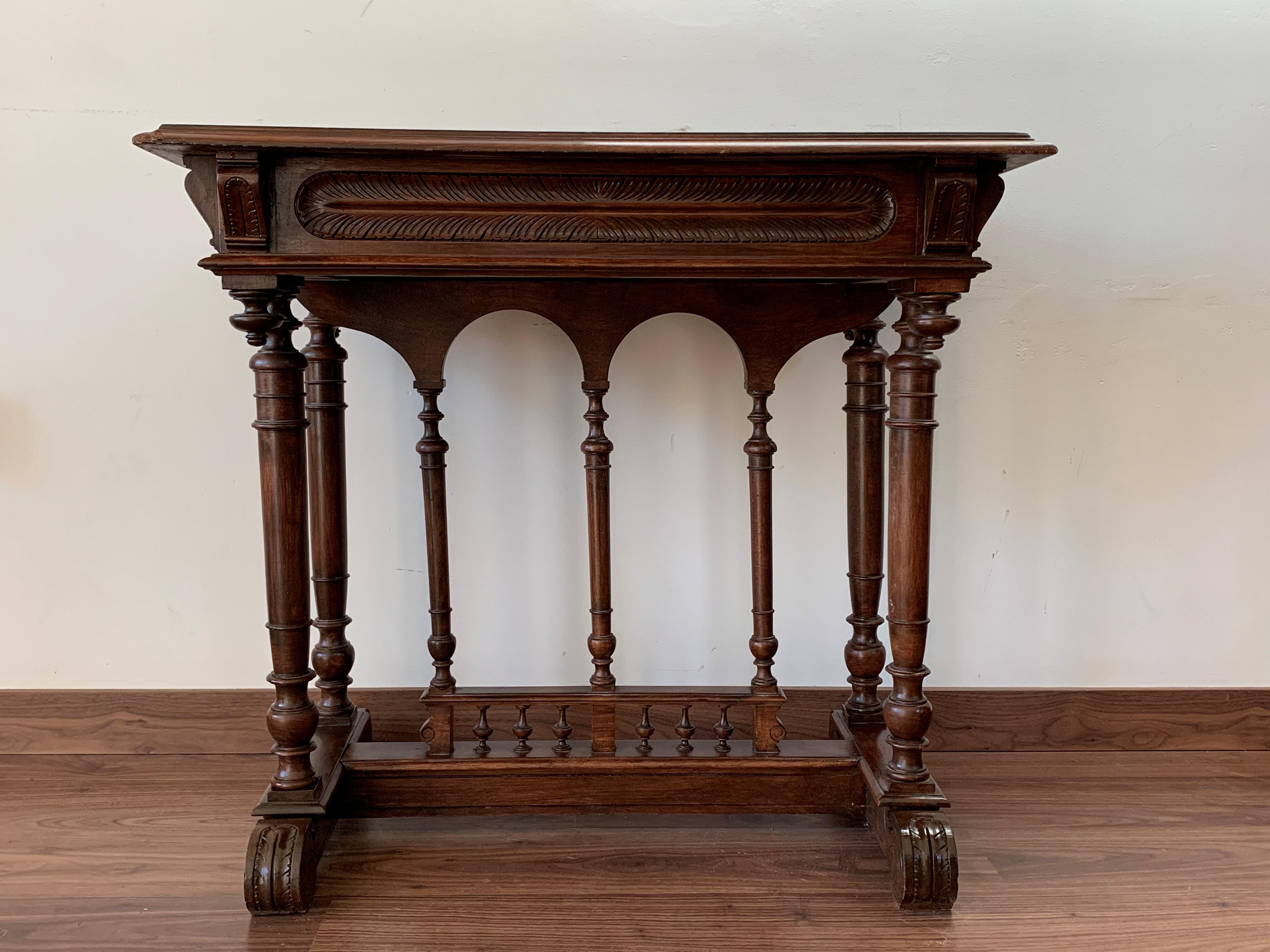 19th century Spanish farm table with wood columns stretchers, hand carved top and drawer.

An unusual form with nice shiny patina. Nice size for a side or end table, or as a lamp table. Graceful carved supports with a shaped edge on the top. The