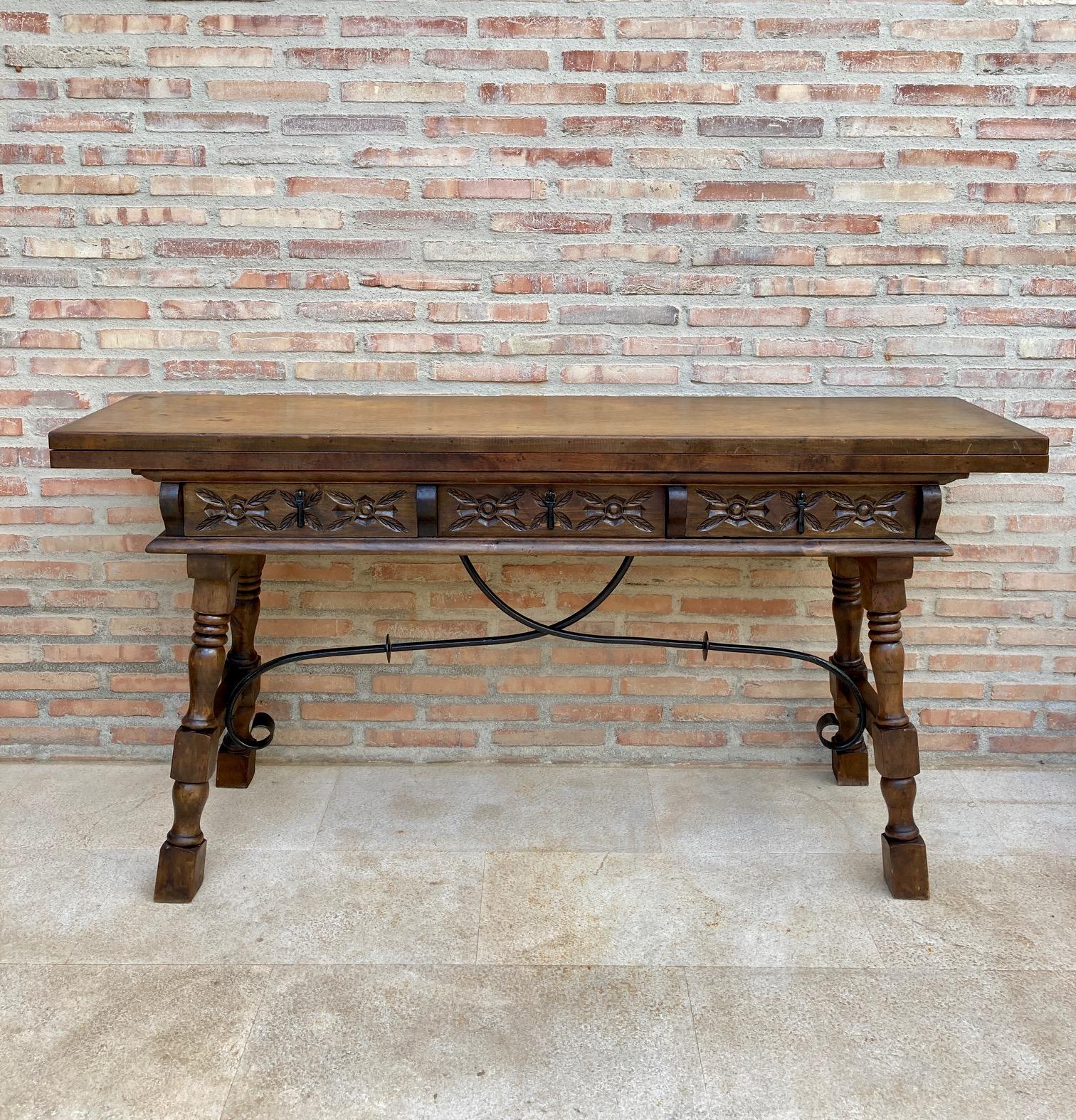 20th century Spanish console fold out farm table with three carved drawers and iron stretcher
Works as both a dining table and console.

Completely restored and waxed.


 