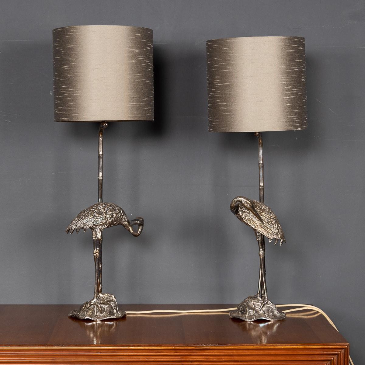 A chic pair of mid 20th Century silver plated lamps, designed by the renowned Spanish designer Valenti. A beautifully crafted base supports the bamboo shape stem, with an integrated crane bird that is the showpiece of the lamp. These lamps offer a