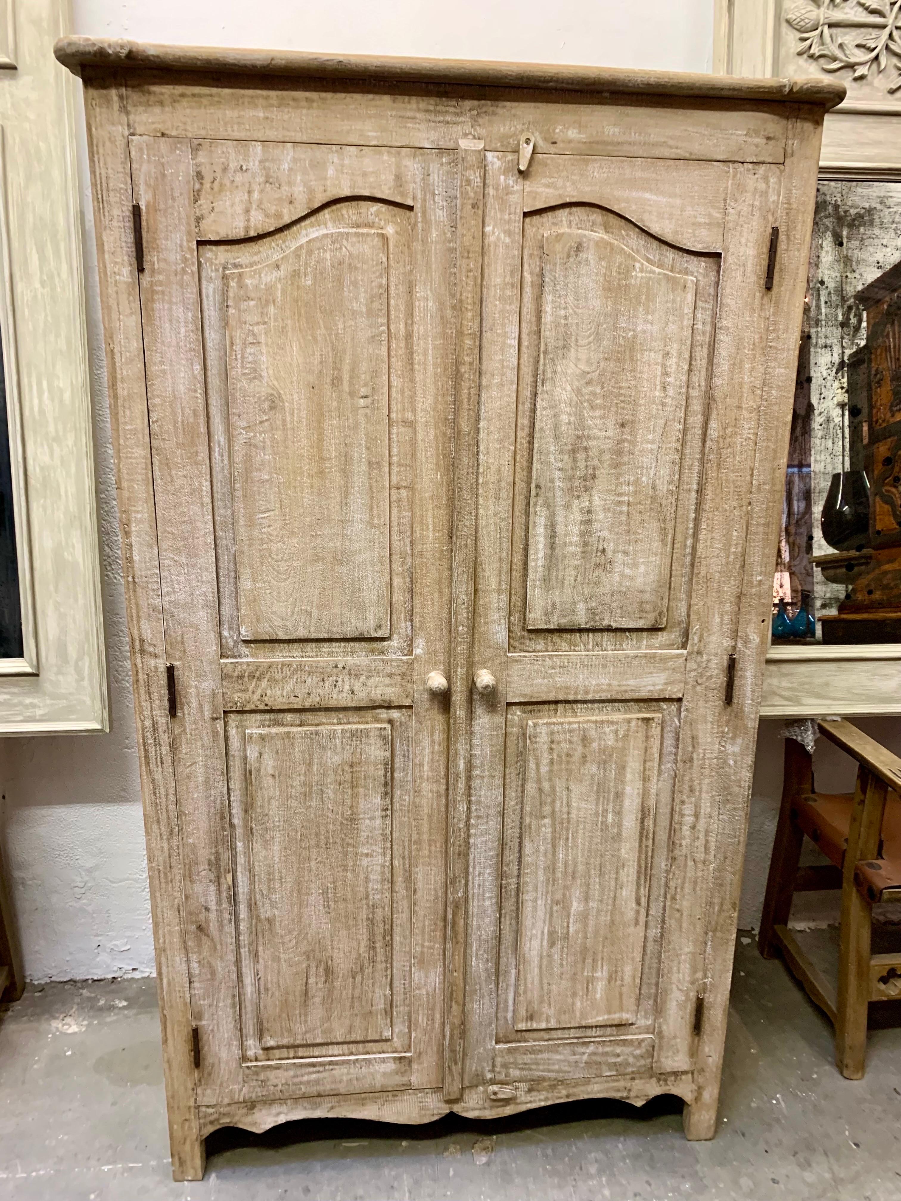 Spanish rustic patinated painted pine wood furniture, early 20th century. The article presents a construction in a single part with two doors, made of solid aged pine wood. The interior is divided into two zones, one with shelves and the other free.