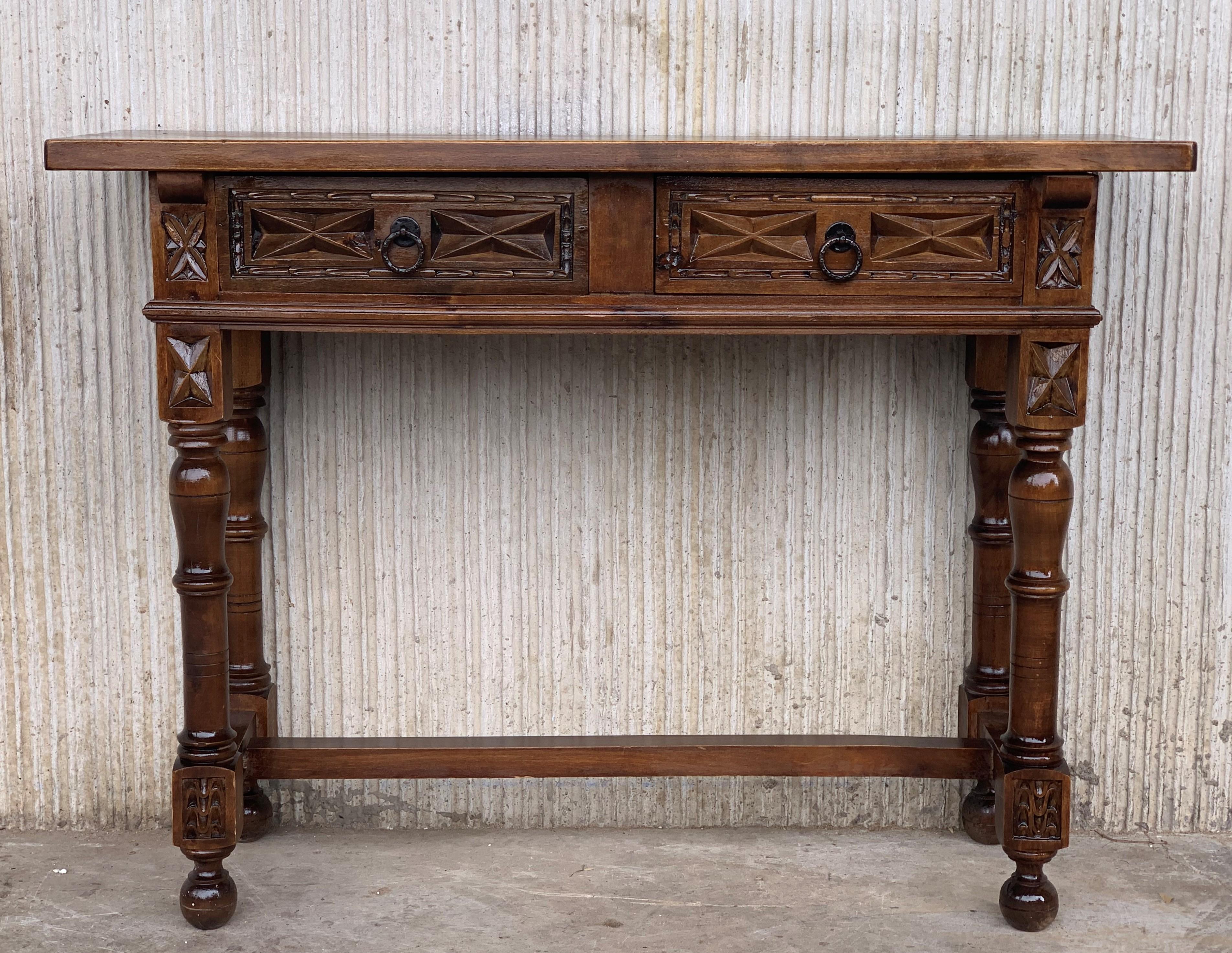 This characterful table is of rare narrow depth of 12.40in. It is characteristic of Spanish Baroque furniture with a thick single piece top, simple bold chip carved ornament and bold turnings. It has a rich lustrous patina.

The thick single plank