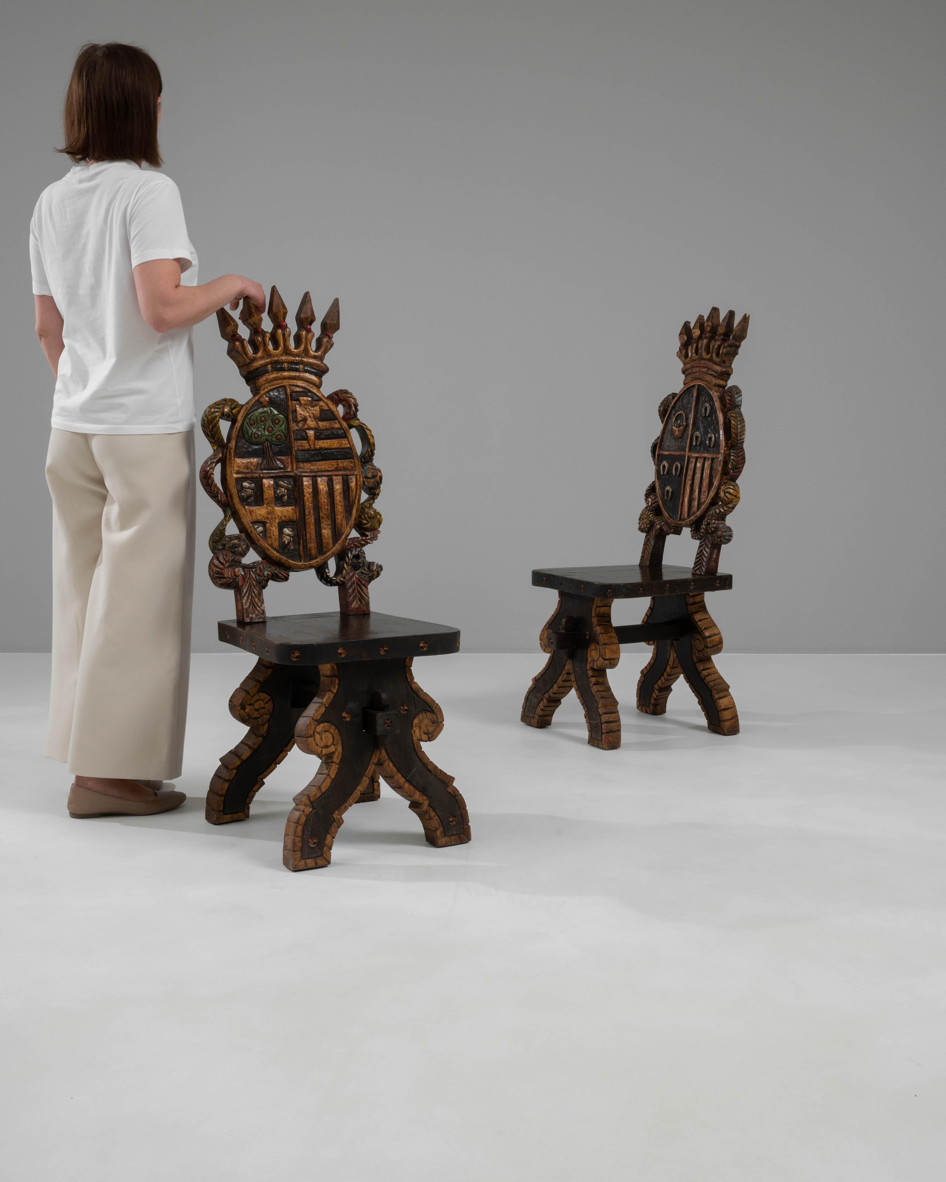 Step into the realm of regal opulence with this extraordinary pair of 20th Century Spanish Wooden Chairs, which are nothing short of a sculptural masterpiece. These chairs are a magnificent tribute to Spanish heritage, featuring meticulously carved