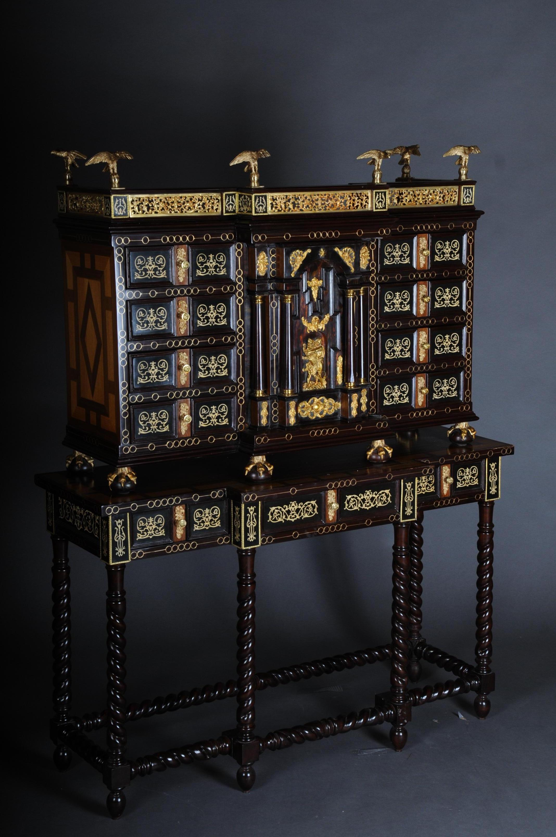 20th century splendid Renaissance tower cabinet

Cabinet cabinet marquetry with inlaid bone on solid wood. A total of 19 richly decorated drawers on the front and inside. Top crowned with brass gallery. In addition, 6 eagles symmetrically