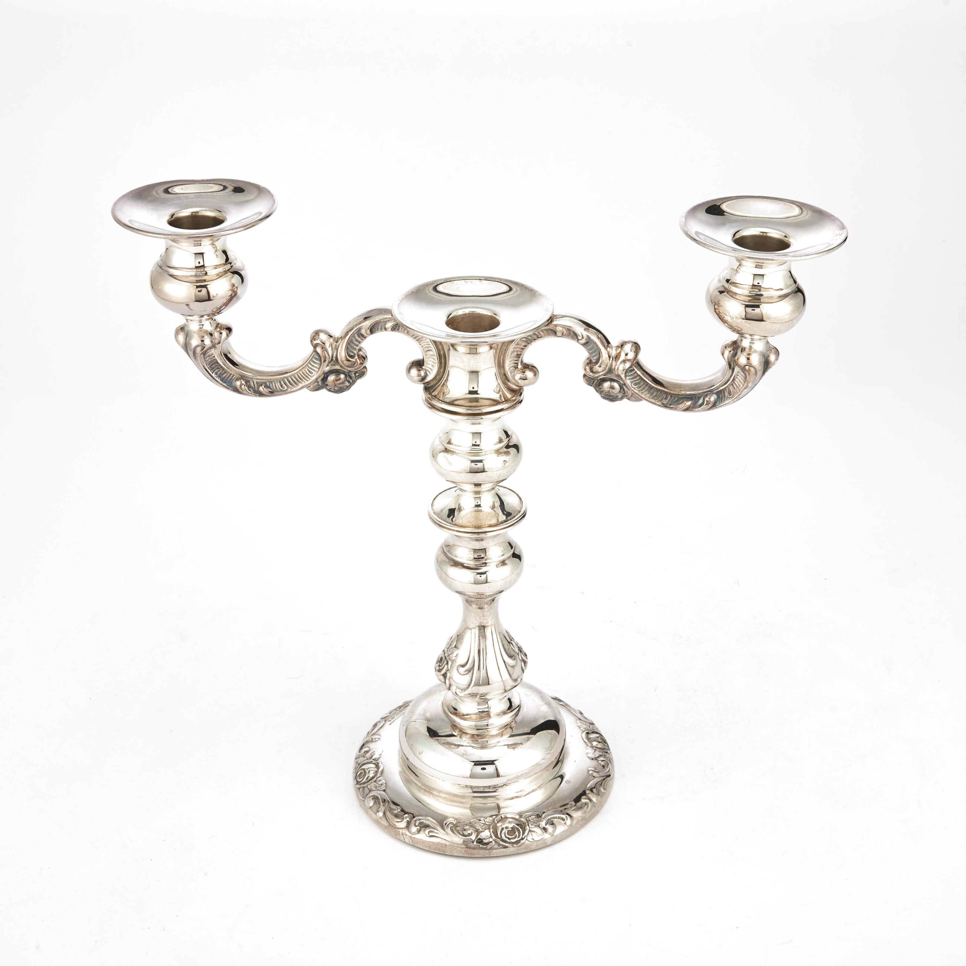 Indulge in the refined elegance of this exquisite five-light Sterling Silver Candelabra, meticulously designed by Spritzer & Fuhrmann. The candelabra is a true work of art, showcasing intricate floral and foliate details on its exterior, elevating