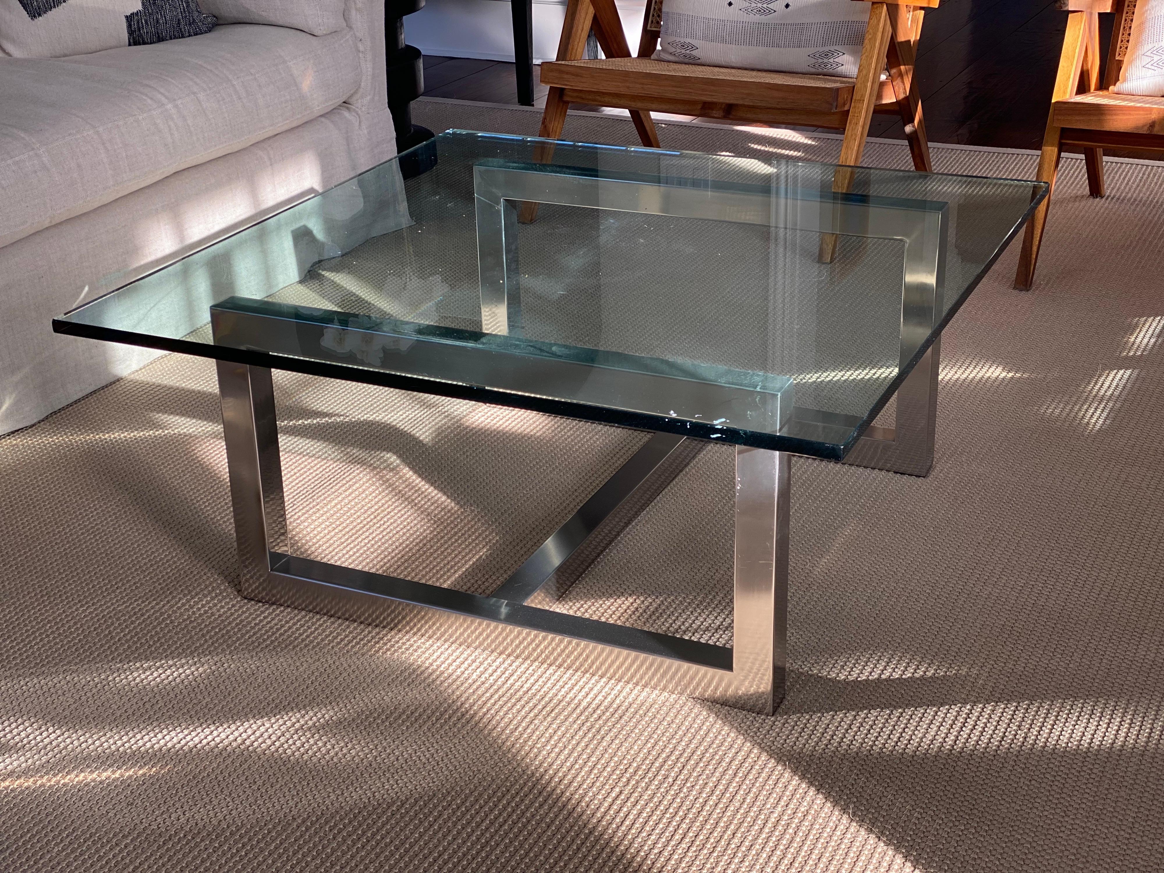 20th Century square glass & chrome coffee table.
Probably from the 80s, chrome H stretcher base with nearly square glass top. 
Glass has some paint on top but looks like it could come off. Only light wear and scuffs.

Measures: 39.88 wide x 40