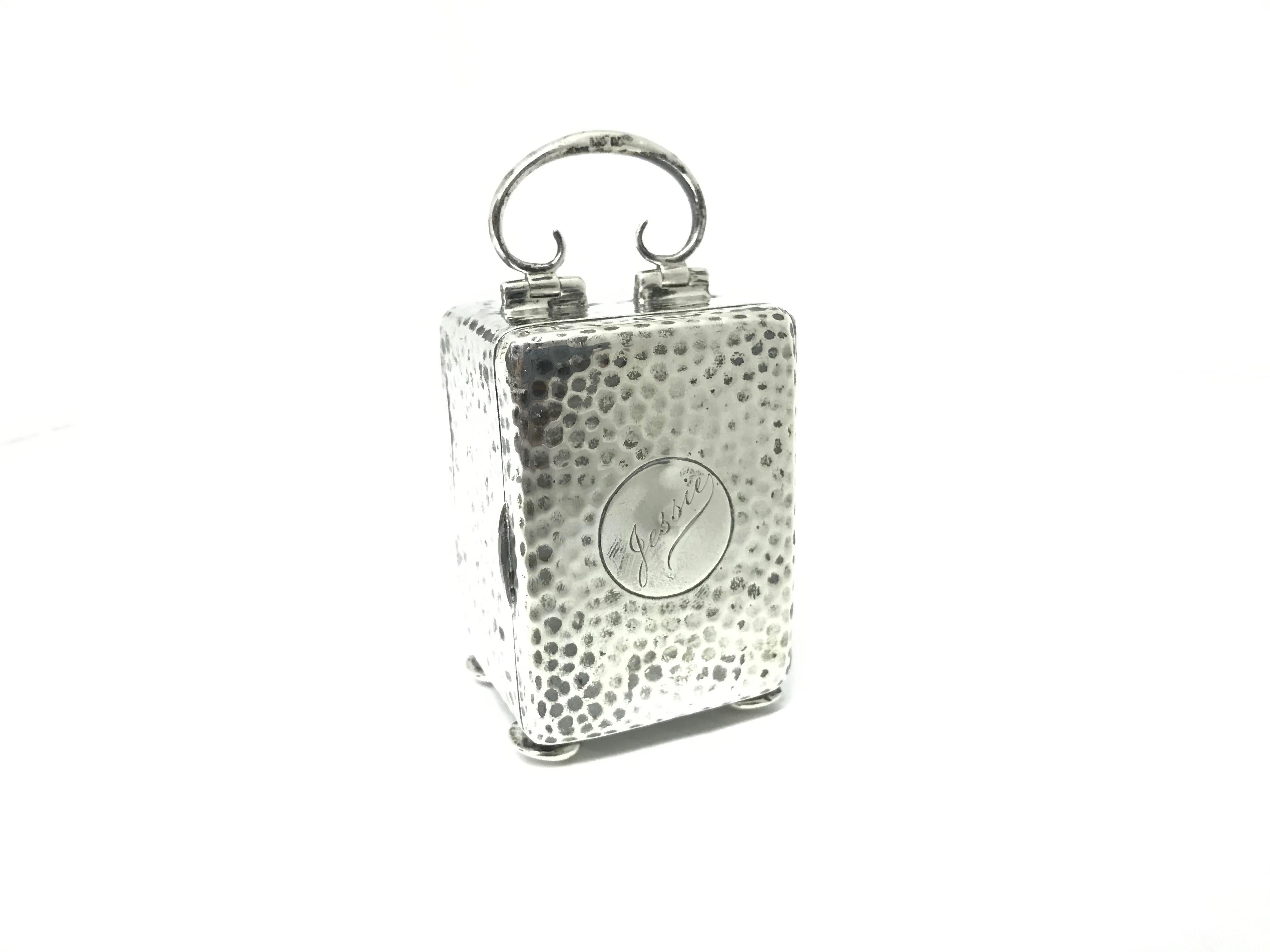 A miniature early 20th century carriage clock in a sterling silver hammered case.
The case is English and hallmarked Birmingham, 1903. The movement was imported
from France which was standard practice in those days. It has and 8-day timepiece