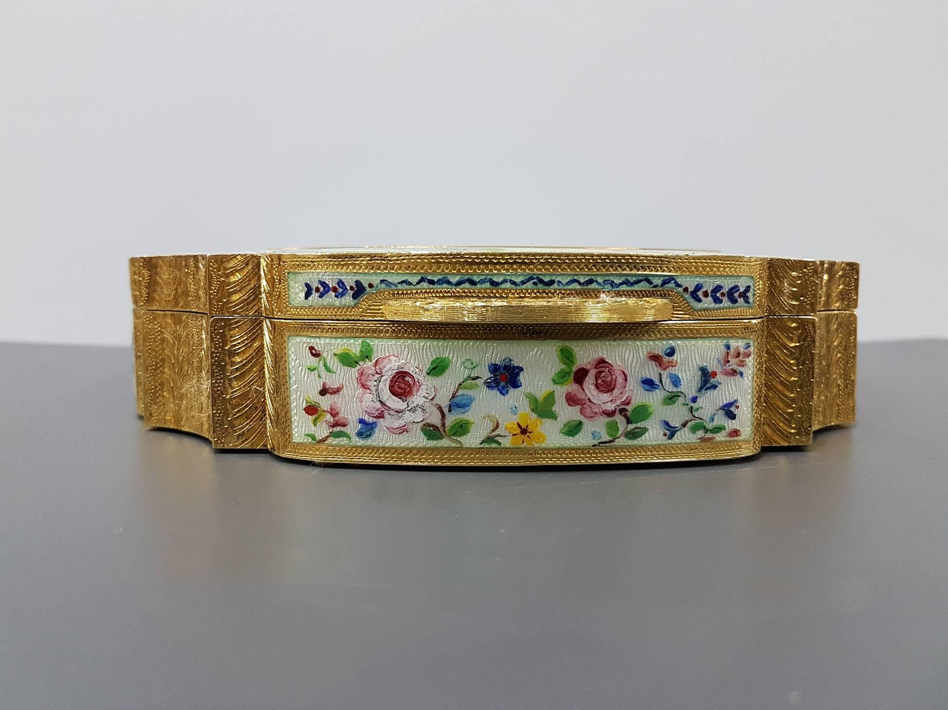 Round haped silver gilded 925/1000 table box with translucent enamels on guilloche with hand-painted floral miniatures and gold paillons
Made in Italy
1.400 grams

The Miniatures are hand-painted on a usually white homogeneous enamel base. The