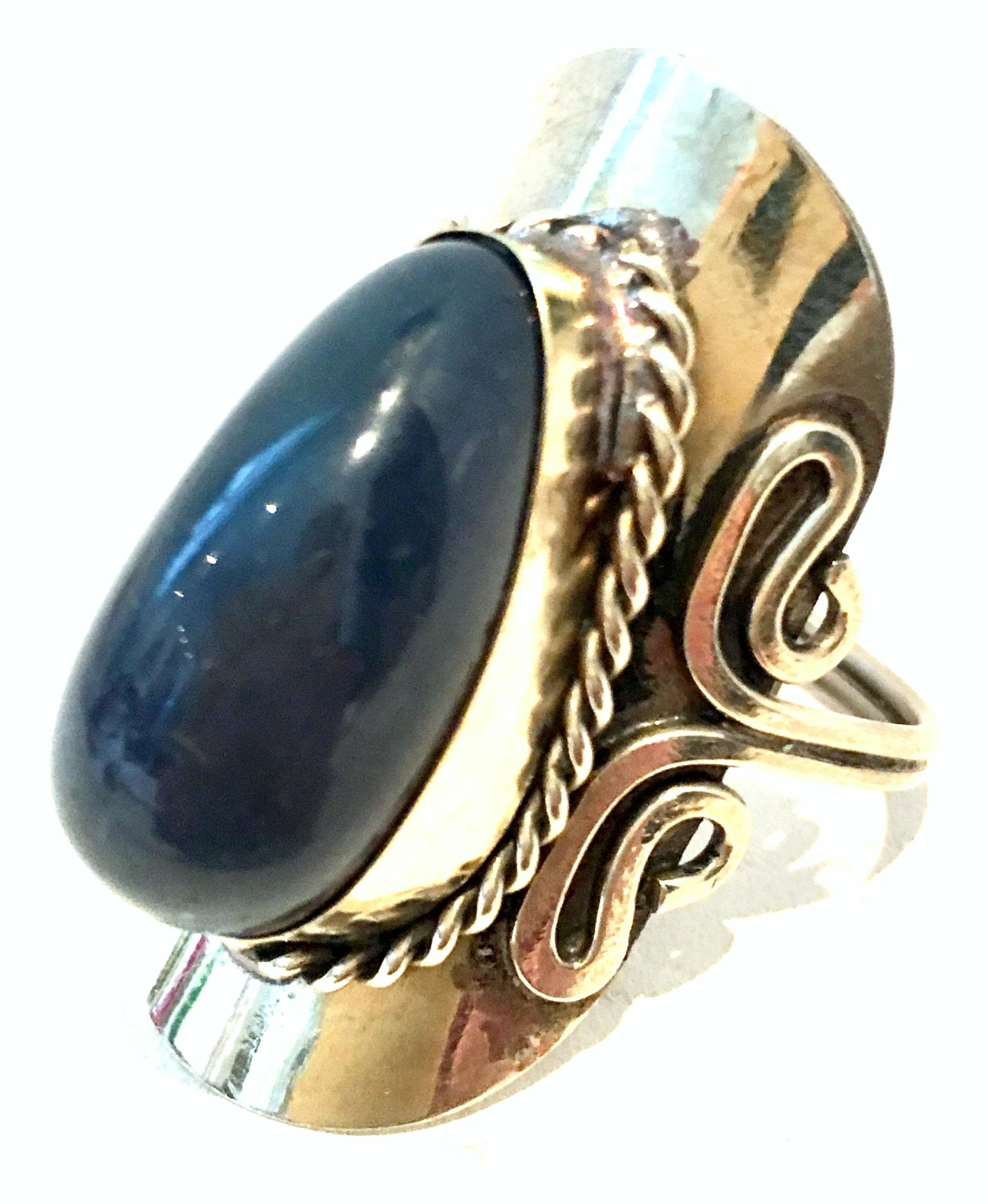 20th Century Sterling Silver & Lapis Lazuli Adjustable Ring Size- One Size. This sterling and large Lapis Lazuli stone adjustable ring can expand to an approximate size 11.  The central cabochon set oblong blue Lapis Lazuli stone measures