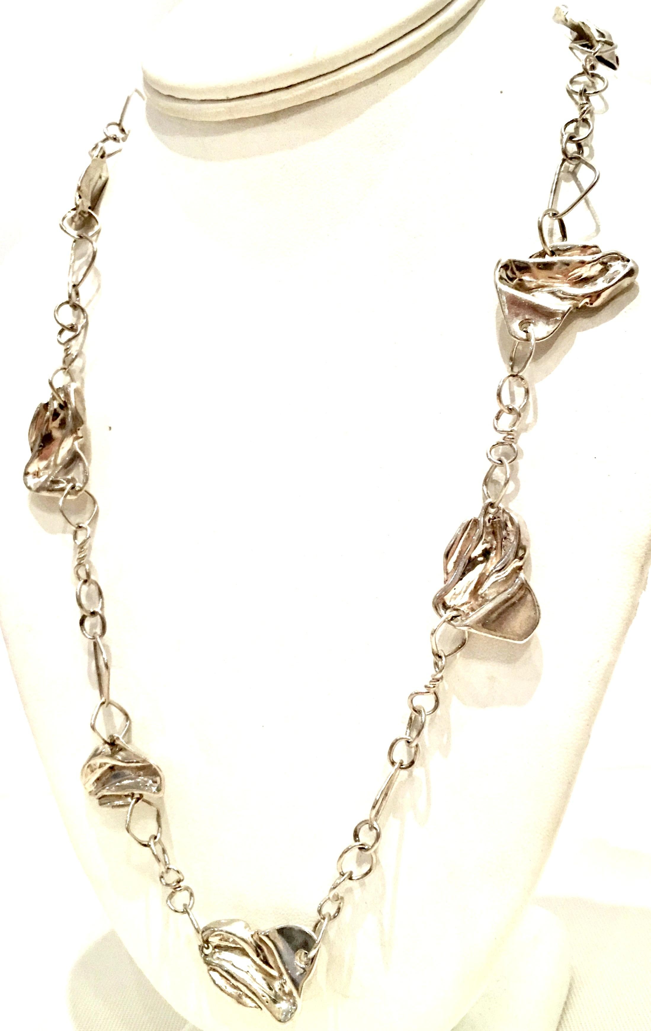 20th Century Sterling Silver Chain Link & Abstract Ornament Necklace. Features ten organic form dimensional ornaments on a chain link necklace. Each of the ten ornaments measure approximately 1