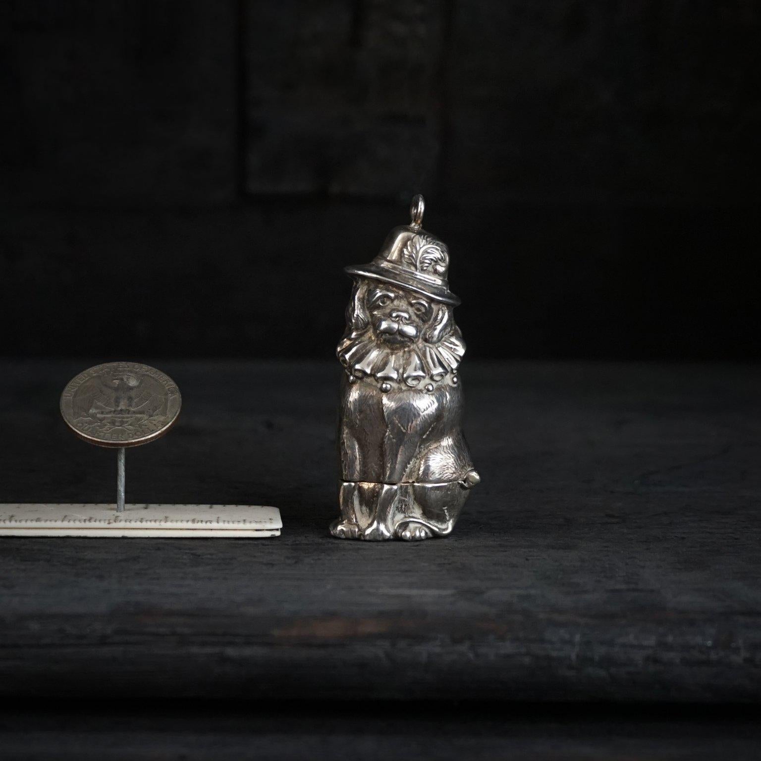 Delightful vintage novelty sterling silver Vesta case or matchbox with a hinged opening and striker to the base. 
Charming item which is made in the form of dog Toby, also known as Mr Punch and Judy's dog. 

This cutie is wearing a plumed hat and a