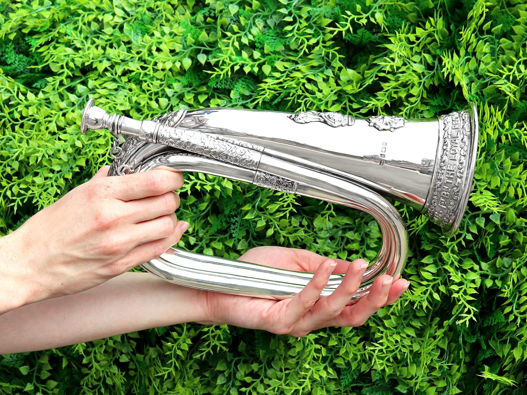 An exceptional, fine and impressive, large antique George V sterling silver regimental bugle; part of our diverse military silverware collection.

This exceptional antique George V sterling silver regimental bugle has a coiling form with a wide