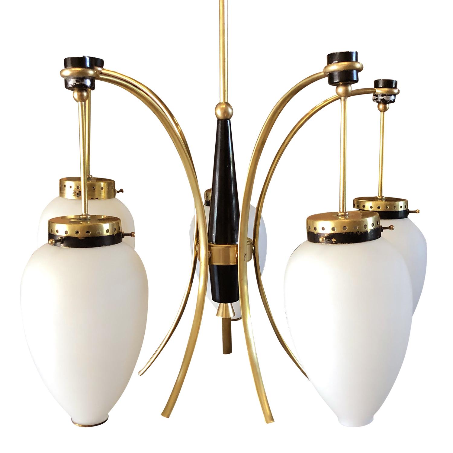A vintage Mid-Century Modern Italian chandelier, pendant made of hand crafted lacquered metal and brass, having four frosted opaline glass light shades supported by slightly curved brass arms, each of them is featured with a one light socket. The