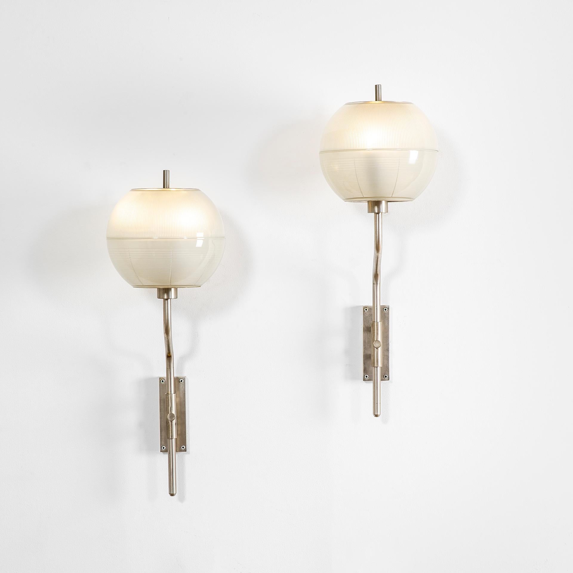 Pair of wall lamps designed by Stilnovo in '50s. This couple of lamps have a chromed metal structure and the diffusers are in satined glass. This design of course remembers something of the famour Pallone Wall Lamps designed by Luigi Caccia