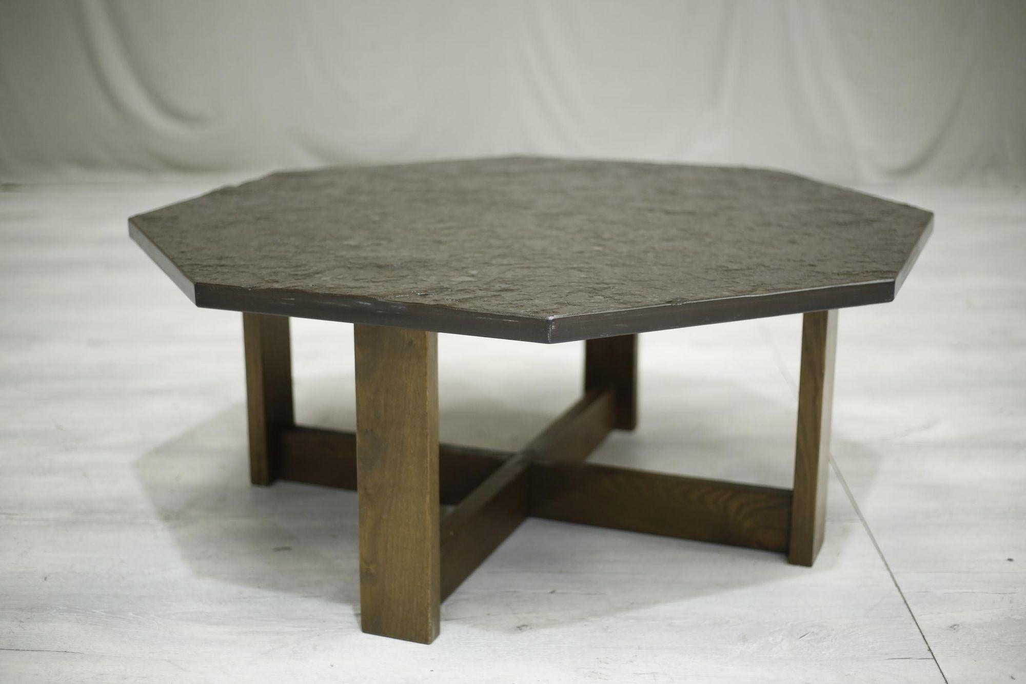 This is a very stylish mid 20th century stone and oak coffee table. The top is riven stone which looks like a form of slate. The colour is superb as it is a warm brown grey which suits the wooden base very nicely. Good size as well making it a real