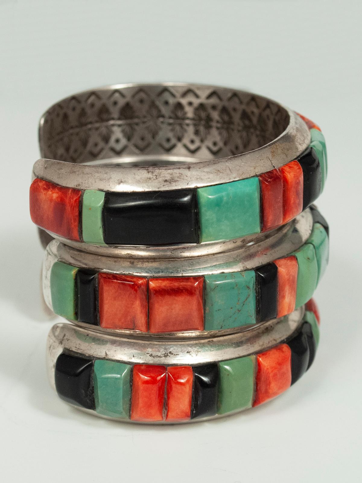 20th century stone and silver bracelets by Ray Adakai, Navajo Jeweler

Each of these colorful silver bracelets has a channel set with rectangular cut spiny oyster shell, turquoise and black onyx cabochons. Master jeweler Ray Adakai is the son of
