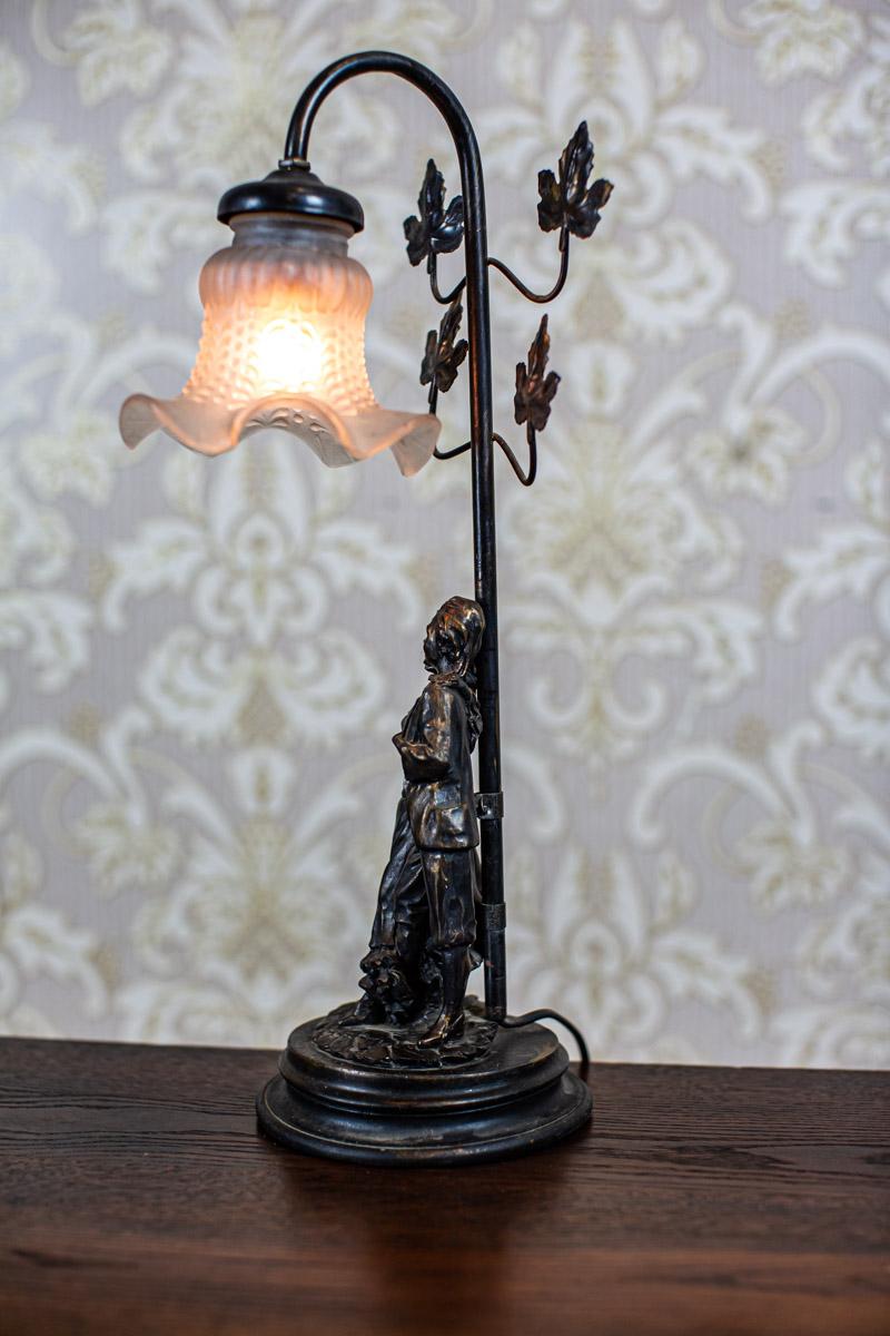 20th-Century Stylized Table Lamp

We present you a small, contemporary lamp, stylized.
There is a socket for a single light bulb.
The power source is 230 V.

This lamp is in particularly good condition.